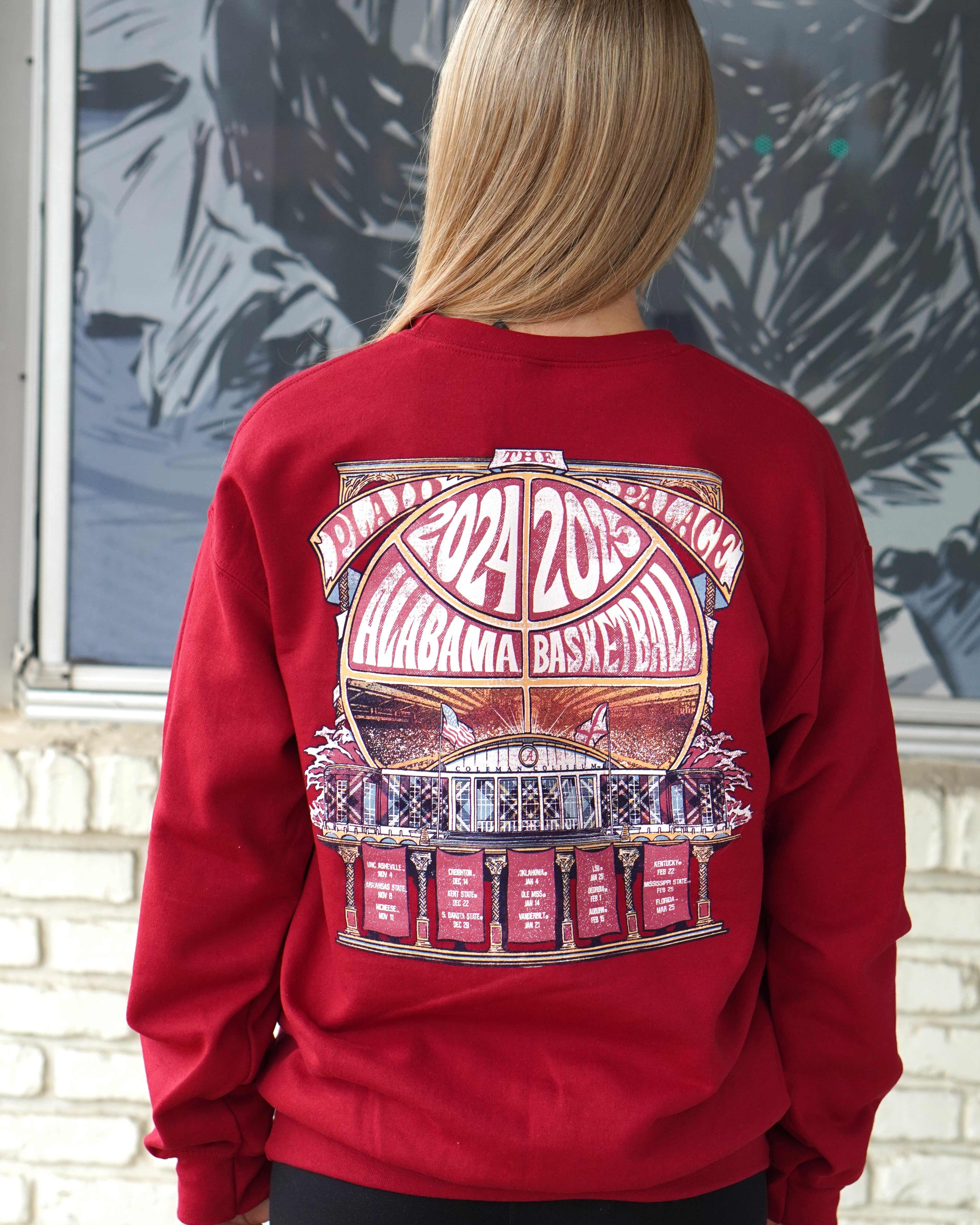 University of Alabama Red Coleman Coliseum Sweatshirt with a graphic of a basketball outline with white text "2024 2025 Alabama Basketball" behind Coleman Coliseum