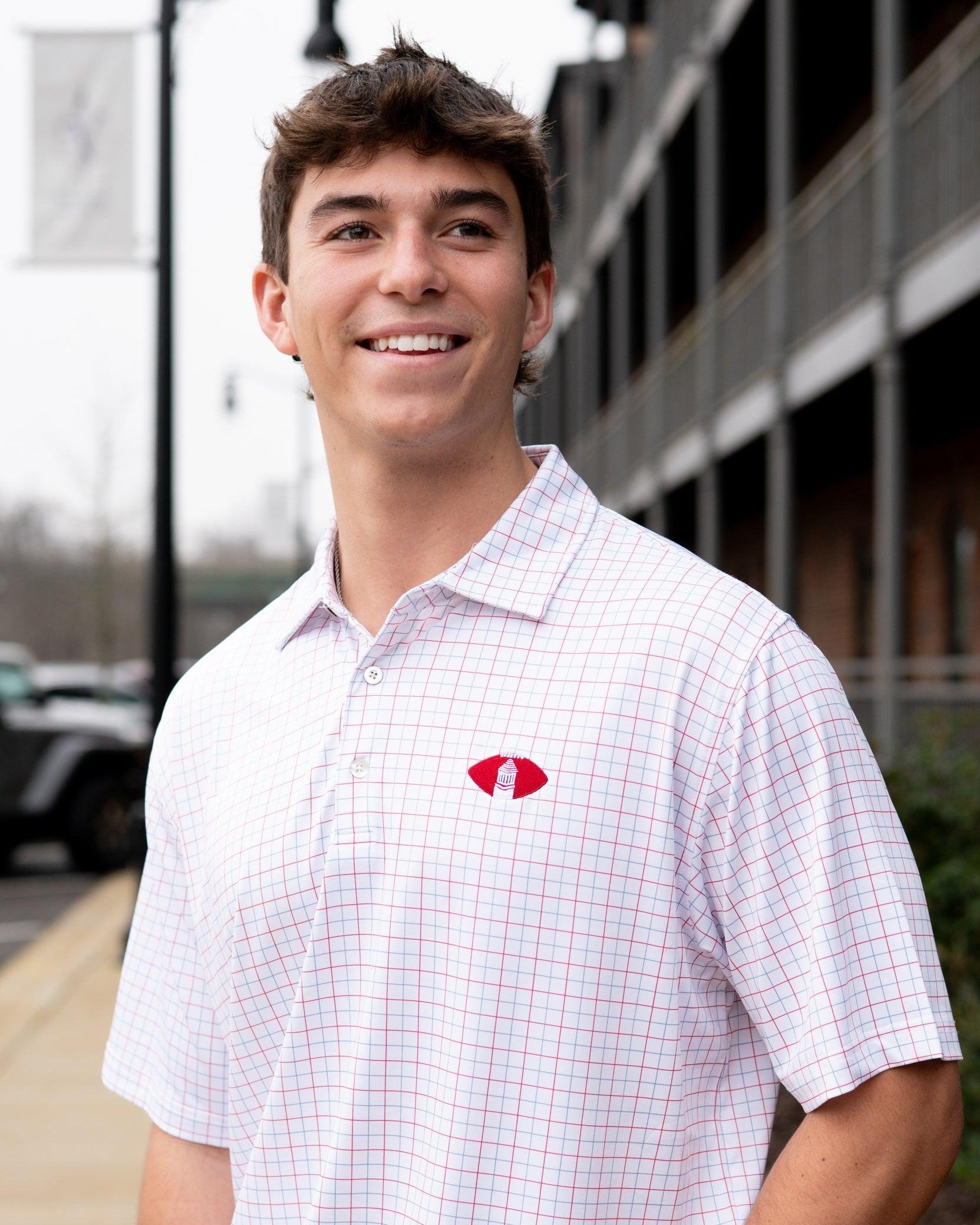 University of Alabama Red/Blue/White patterned Men’s Polo with Denney Chimes in a football embroidered on the chest