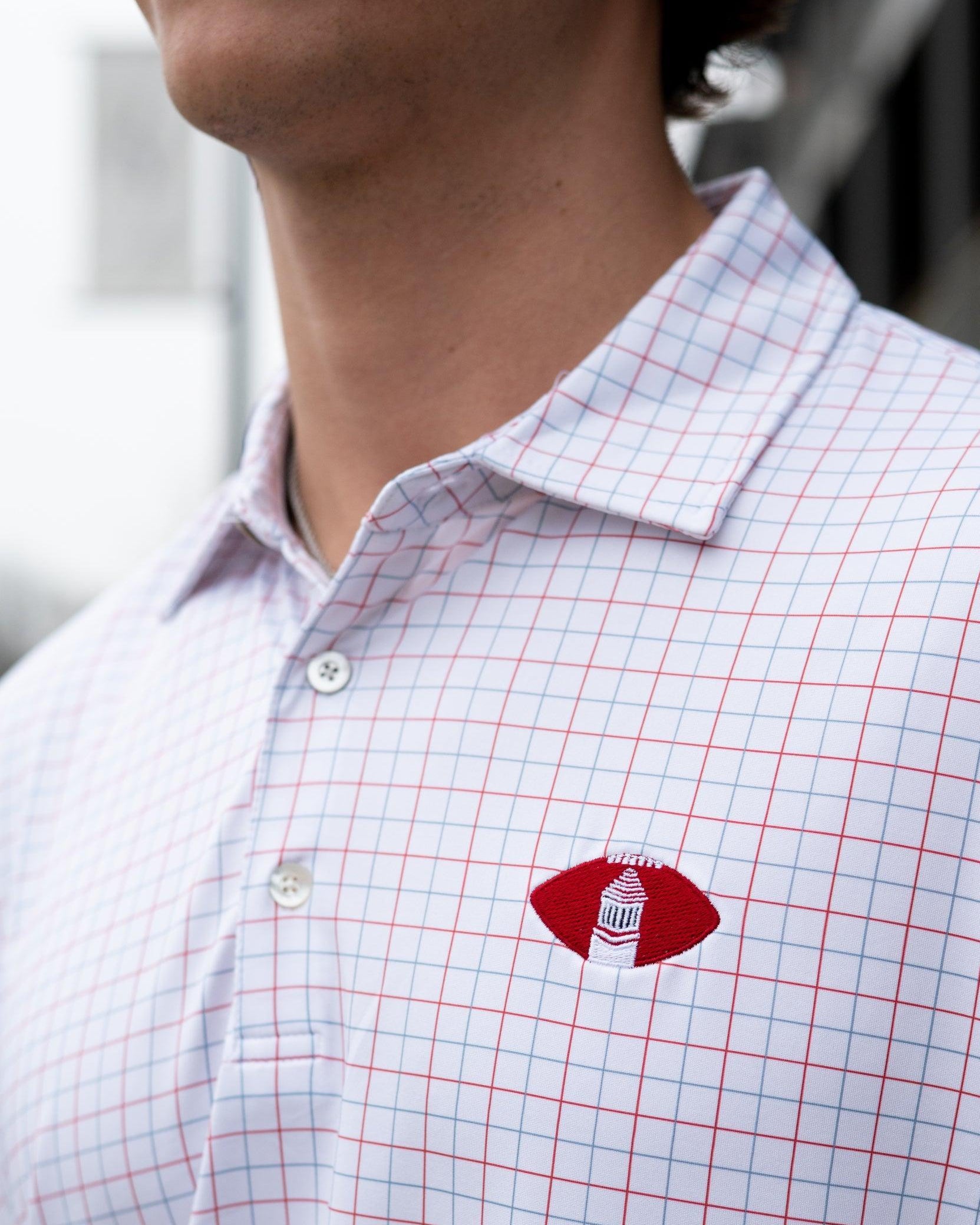 University of Alabama Red/Blue/White patterned Men’s Polo with Denney Chimes in a football embroidered on the chest