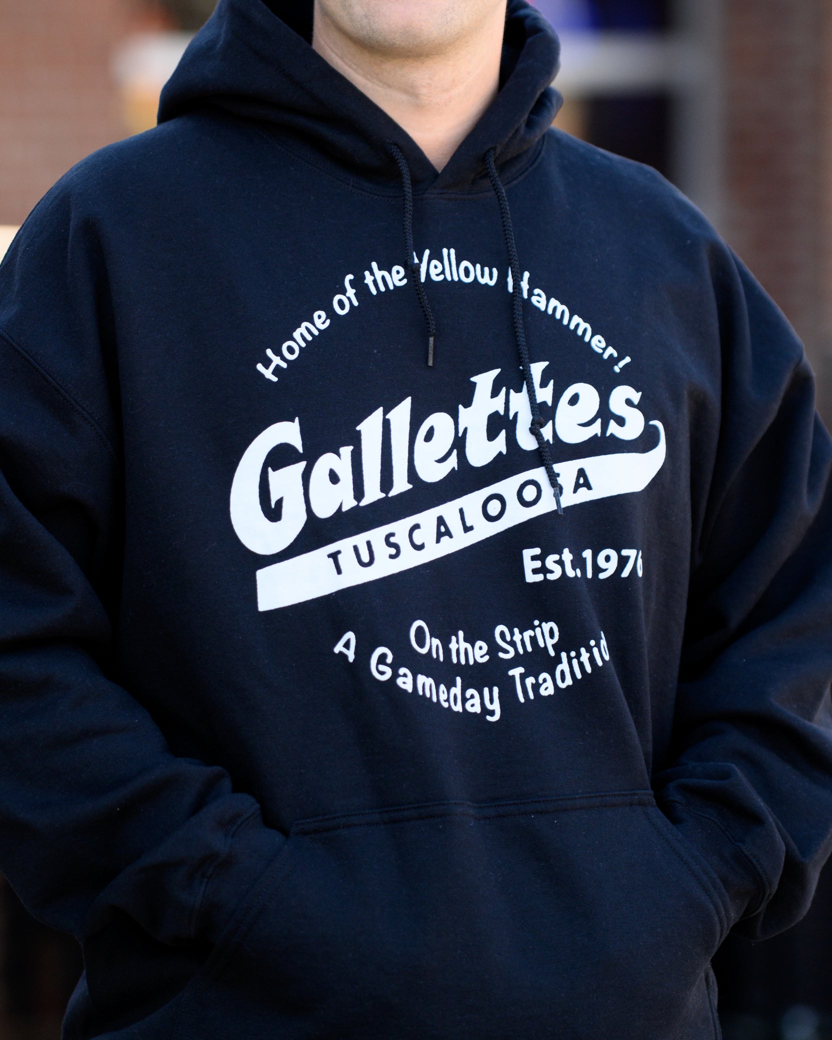 Gallettes Black Hoodie with a White Gallettes logo surrounded by White text "Home of the Yellow Hammer!" and "On the Strip- A Gameday Tradition"