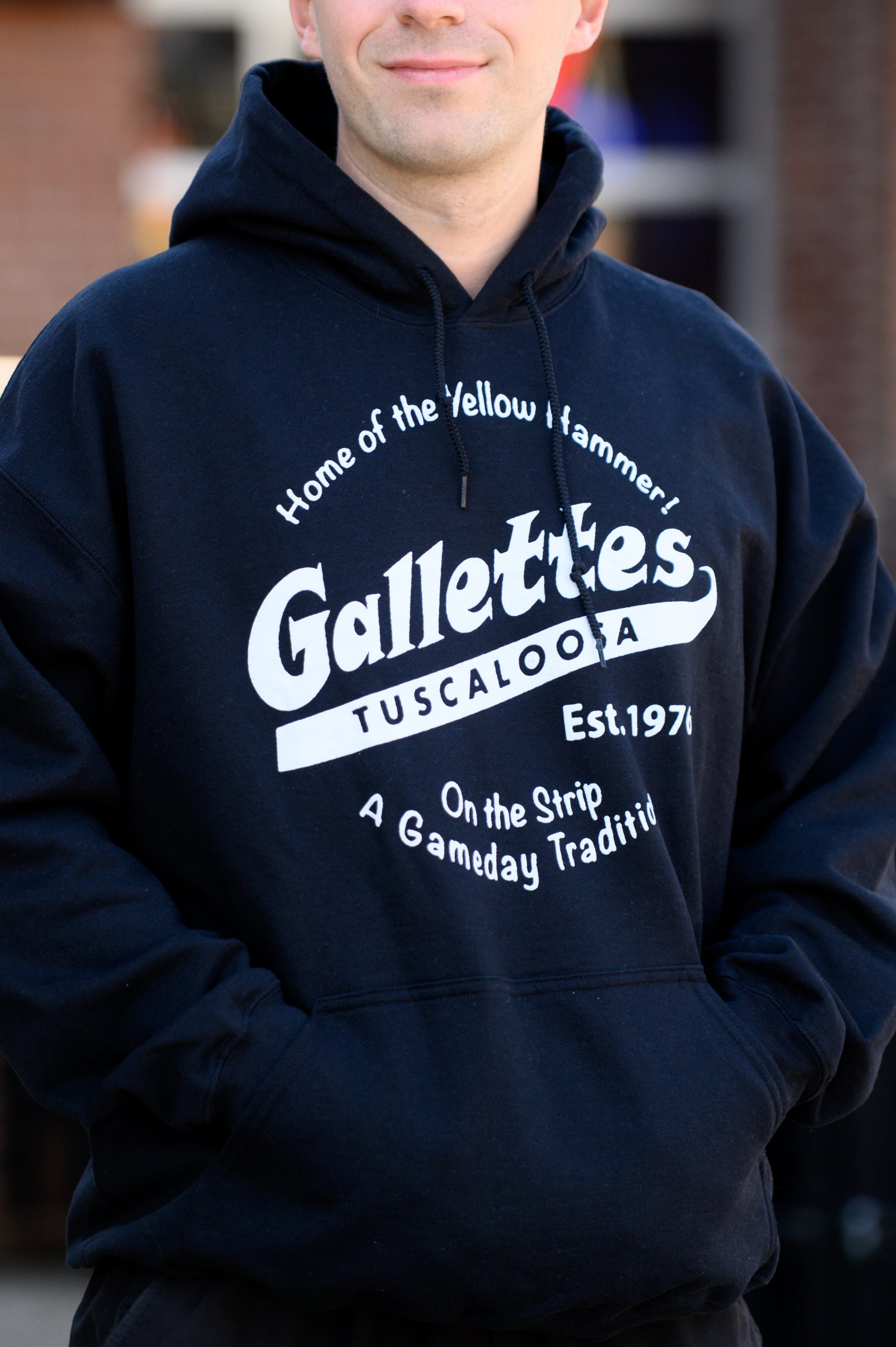 Gallettes Black Hoodie with a White Gallettes logo surrounded by White text "Home of the Yellow Hammer!" and "On the Strip- A Gameday Tradition"