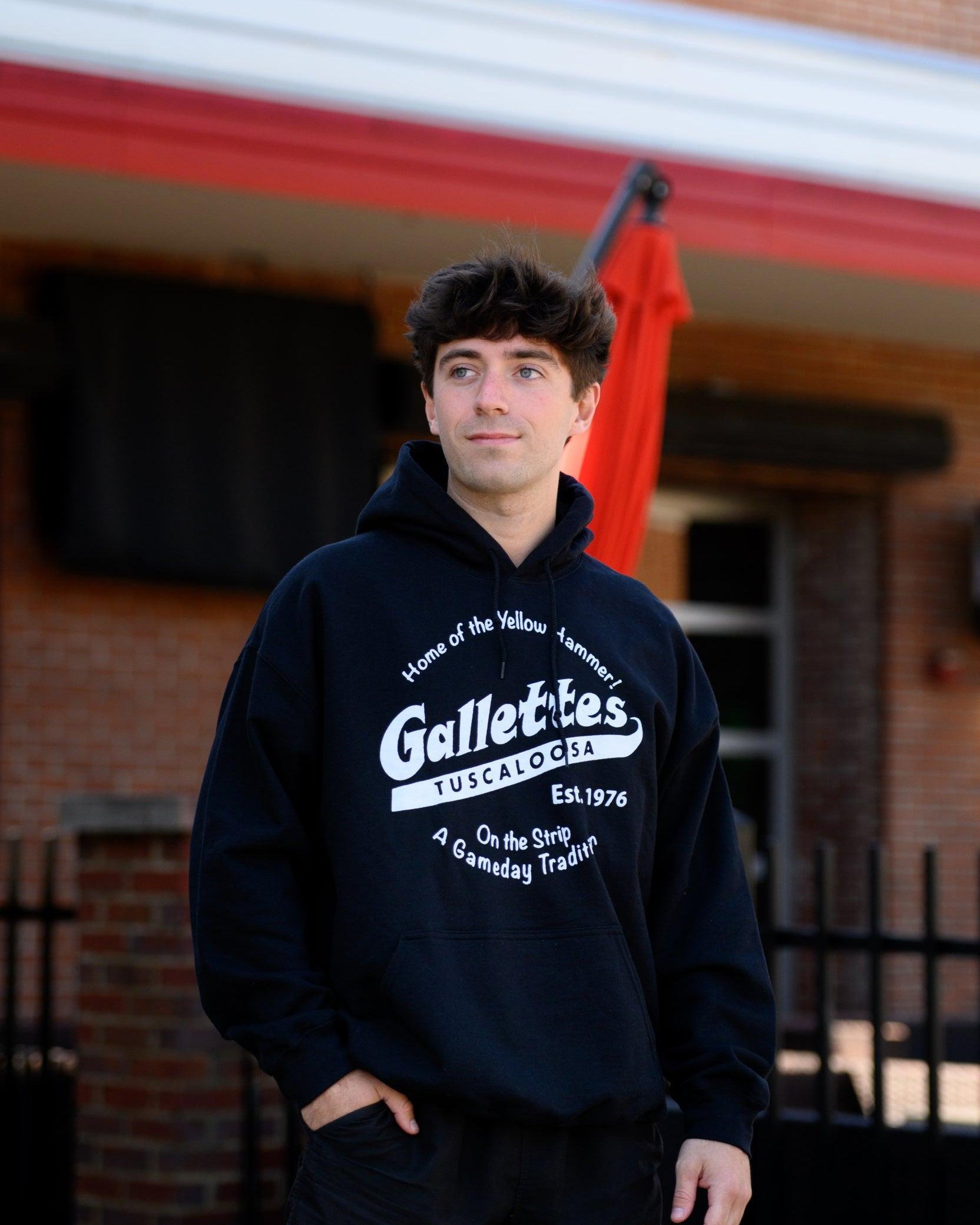 Gallettes Black Hoodie with a White Gallettes logo surrounded by White text "Home of the Yellow Hammer!" and "On the Strip- A Gameday Tradition"