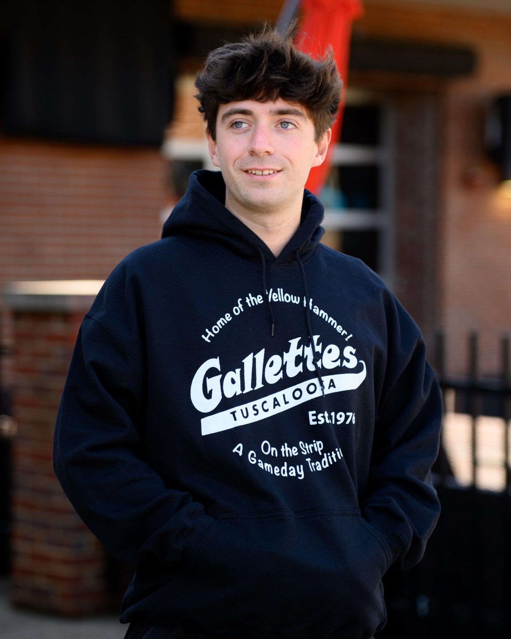 Gallettes Black Hoodie with a White Gallettes logo surrounded by White text "Home of the Yellow Hammer!" and "On the Strip- A Gameday Tradition"