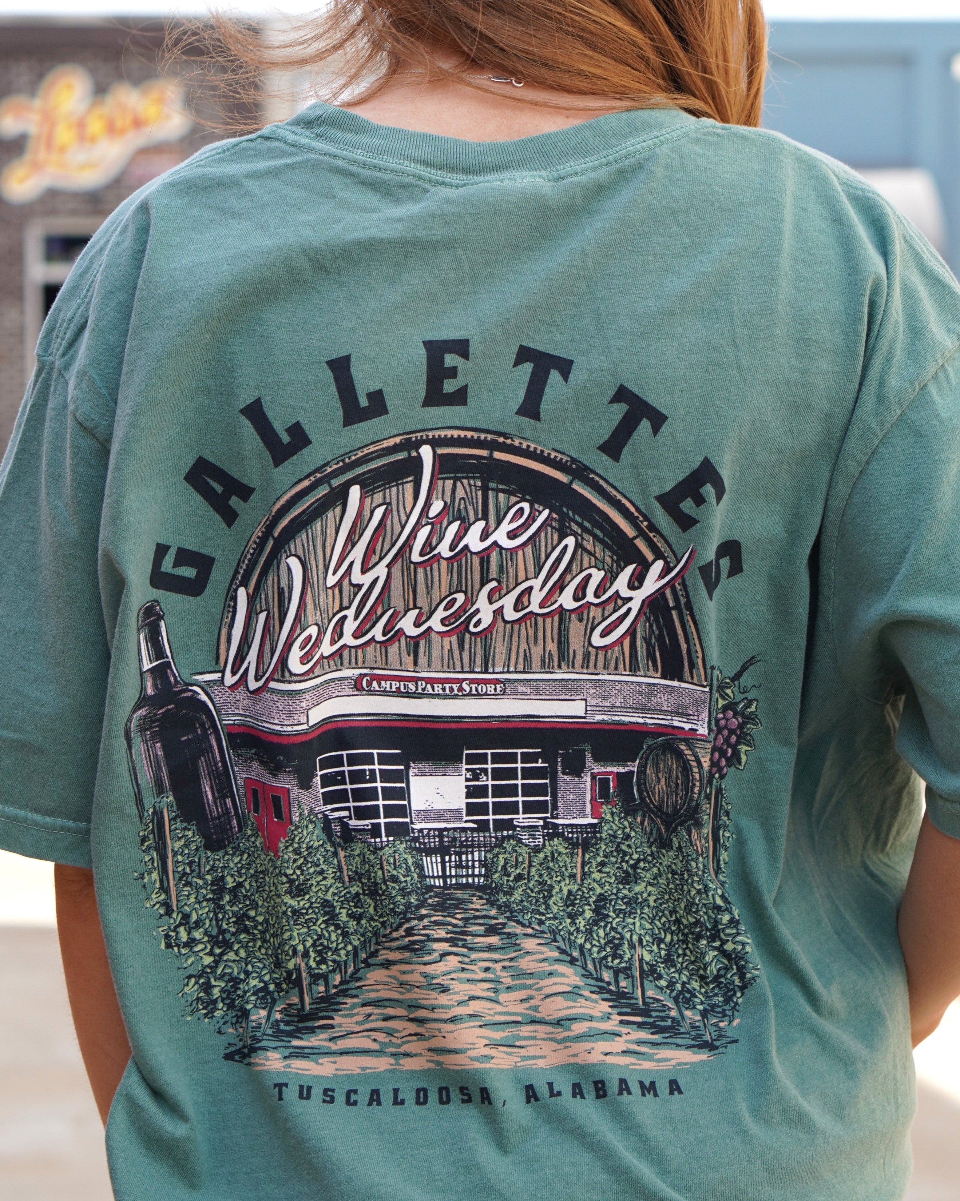 Gallettes Green Wine Wednesday T-Shirt with an image of the Gallettes Building in a vineyard in front of a wine barrel with White text "Wine Wednesday