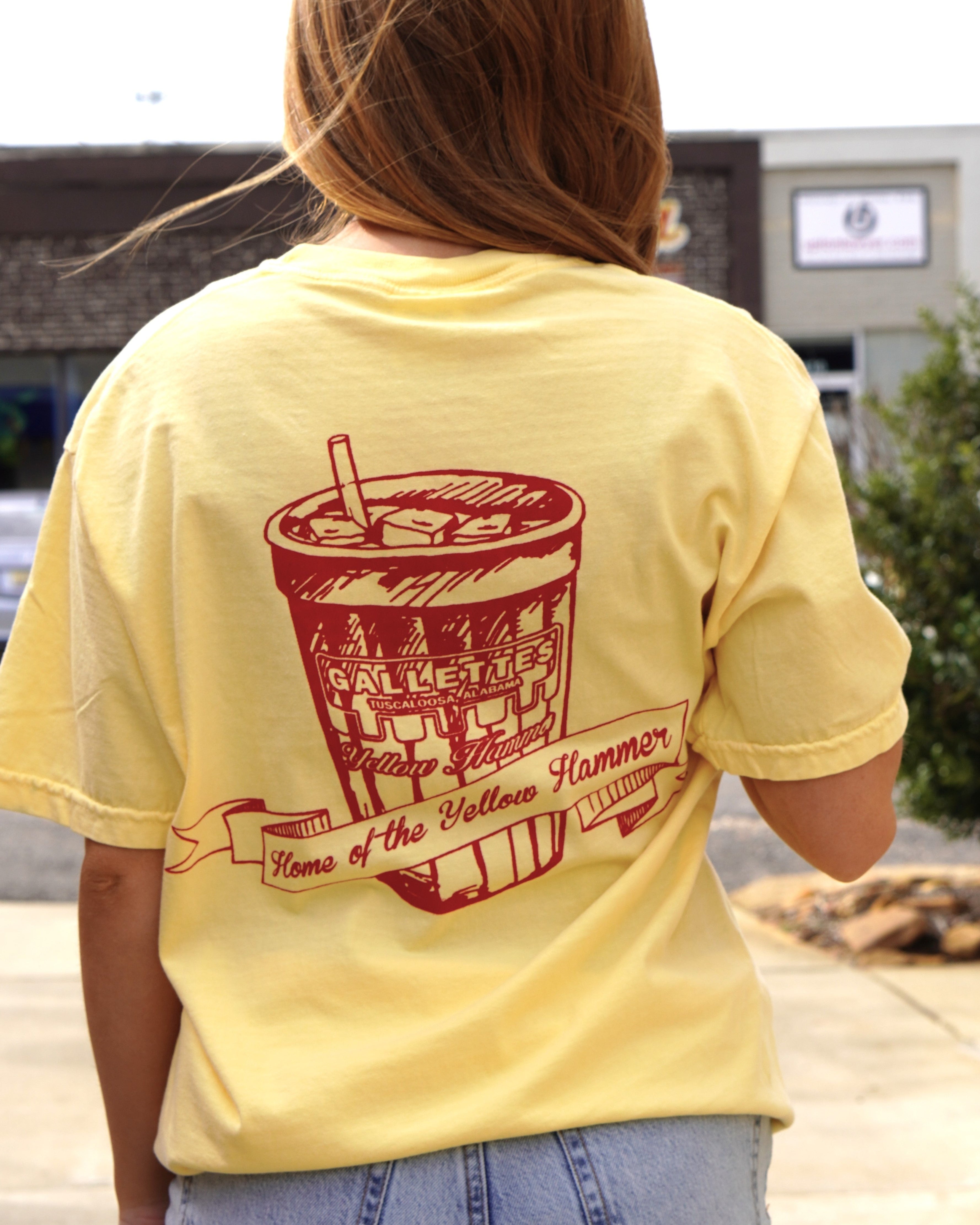 Gallettes Yellow T-Shirt with a Red illustration of a full Gallettes cup behind a banner with  text "Home of the Yellow Hammer" and a Font Pocket with Red "I Got Yellow Hammered"