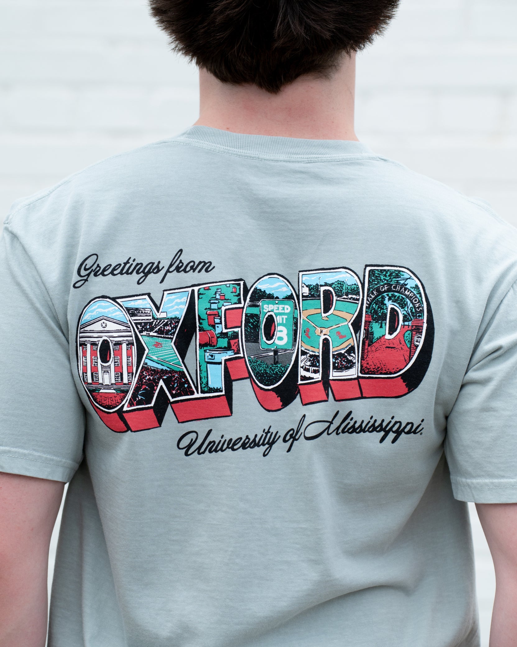 Ole Miss Green T-Shirt with postcard style text "Greetings From OXFORD" with "Oxford" filled with images of iconic buildings in that location