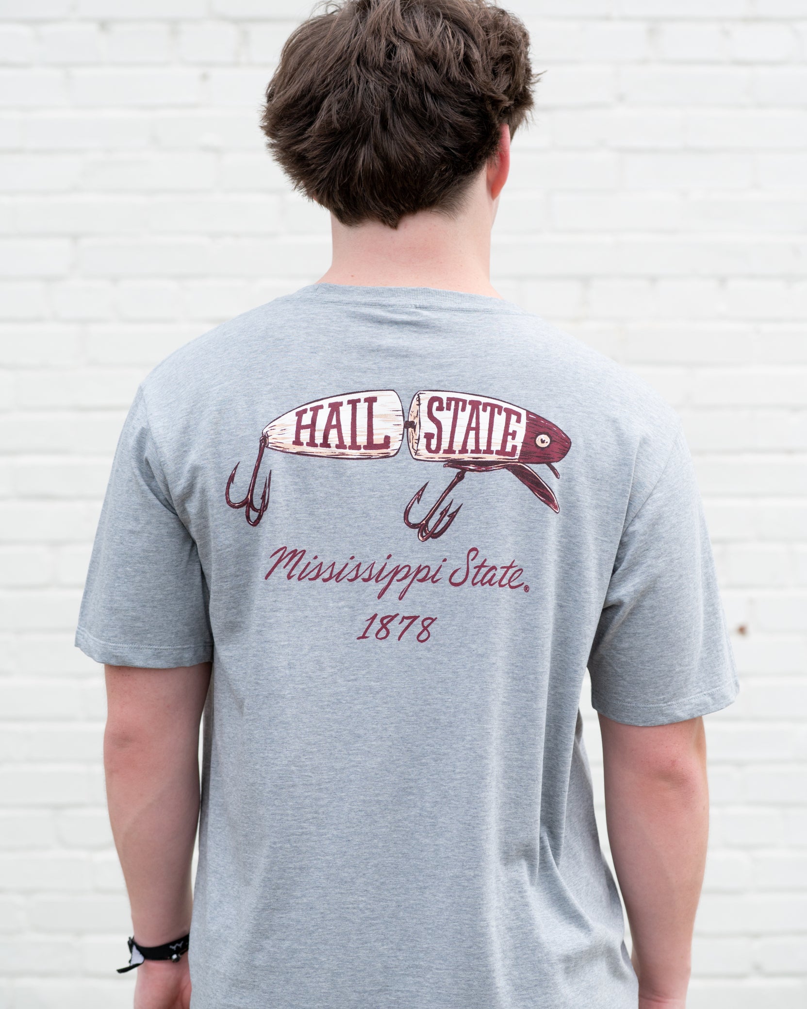 Mississippi State Grey T-Shirt with an image of a fishing lure with Red text “Hail State”