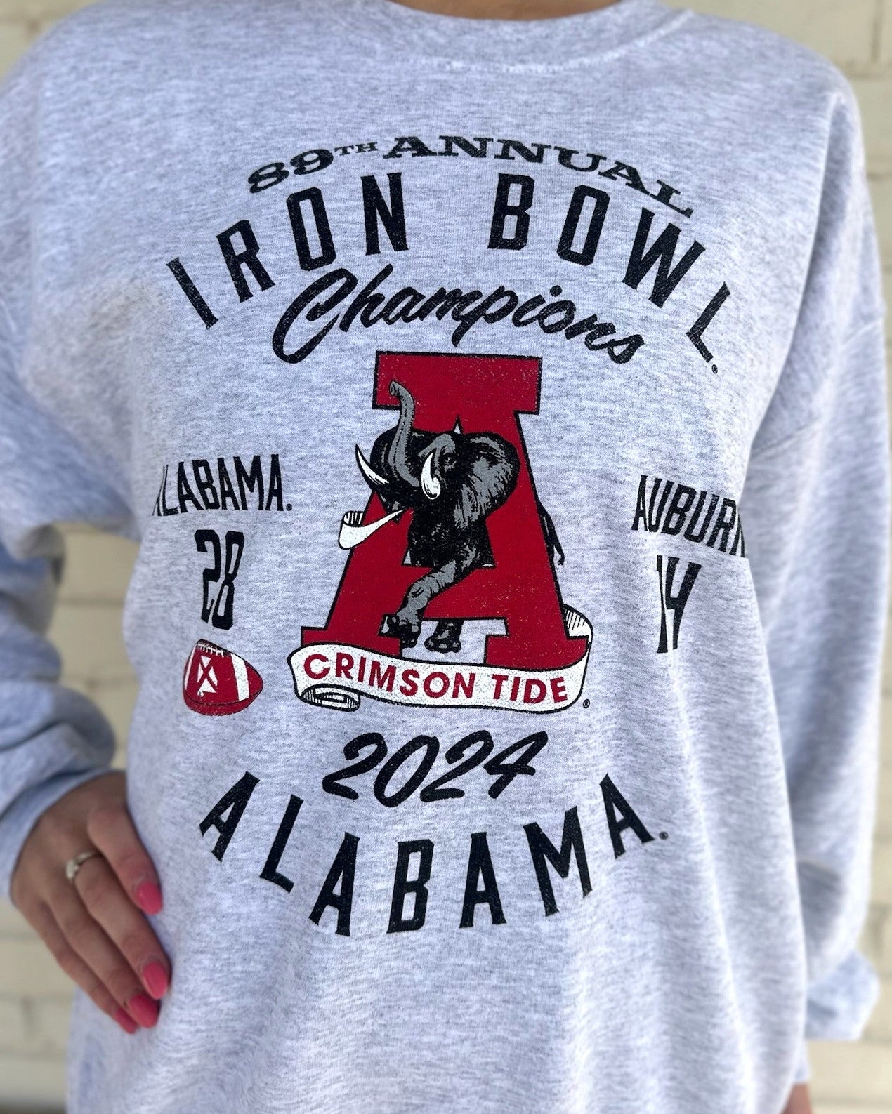 University of Alabama Grey 2024 Iron Bowl Champions Sweatshirts with the Vintage A logo surrounded by Black text detailing the winning score and the year