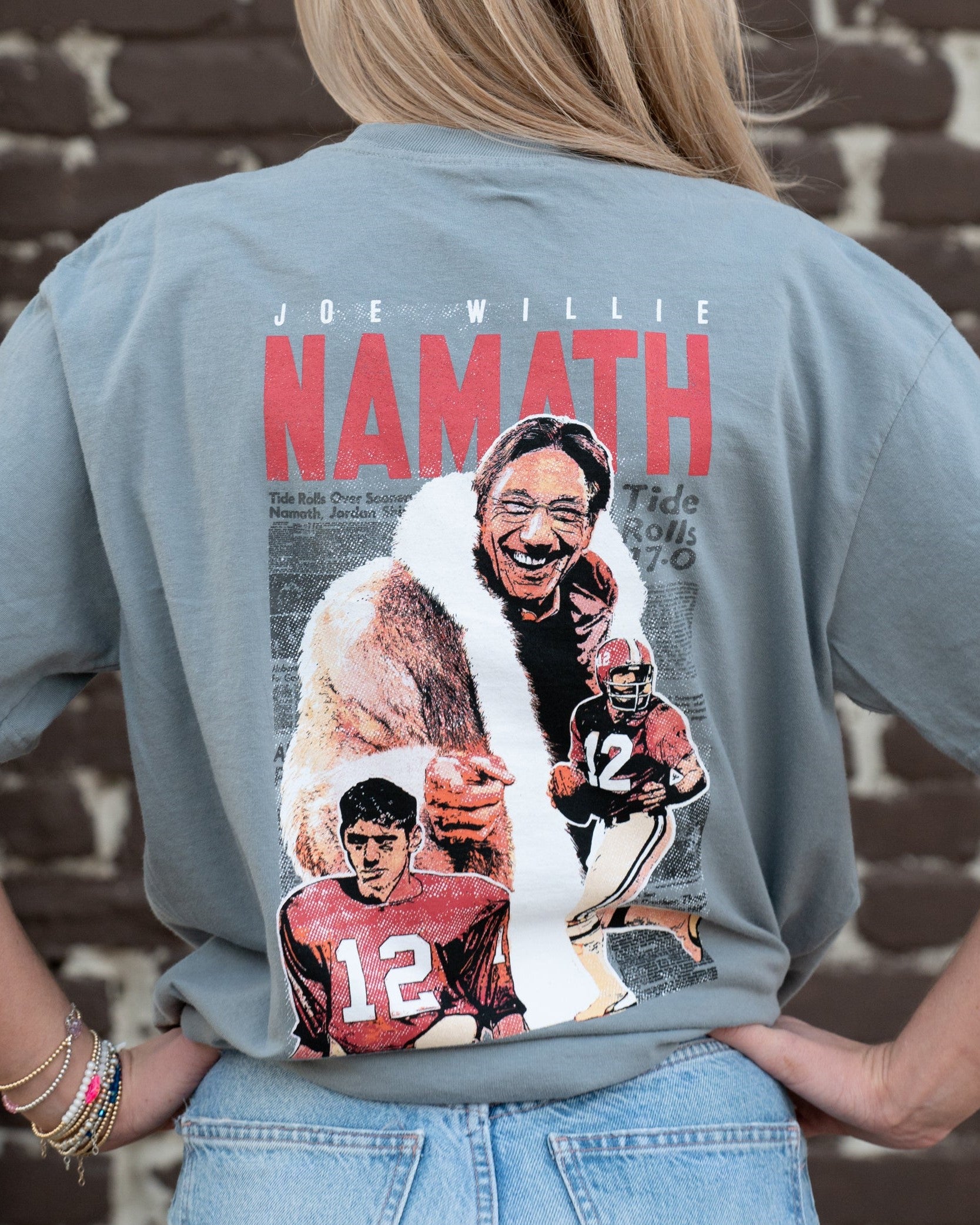 University of Alabama Grey Namath T-Shirt with a graphic design of Joe Willie Namath, featuring images of Namath playing football and holding a trophy.