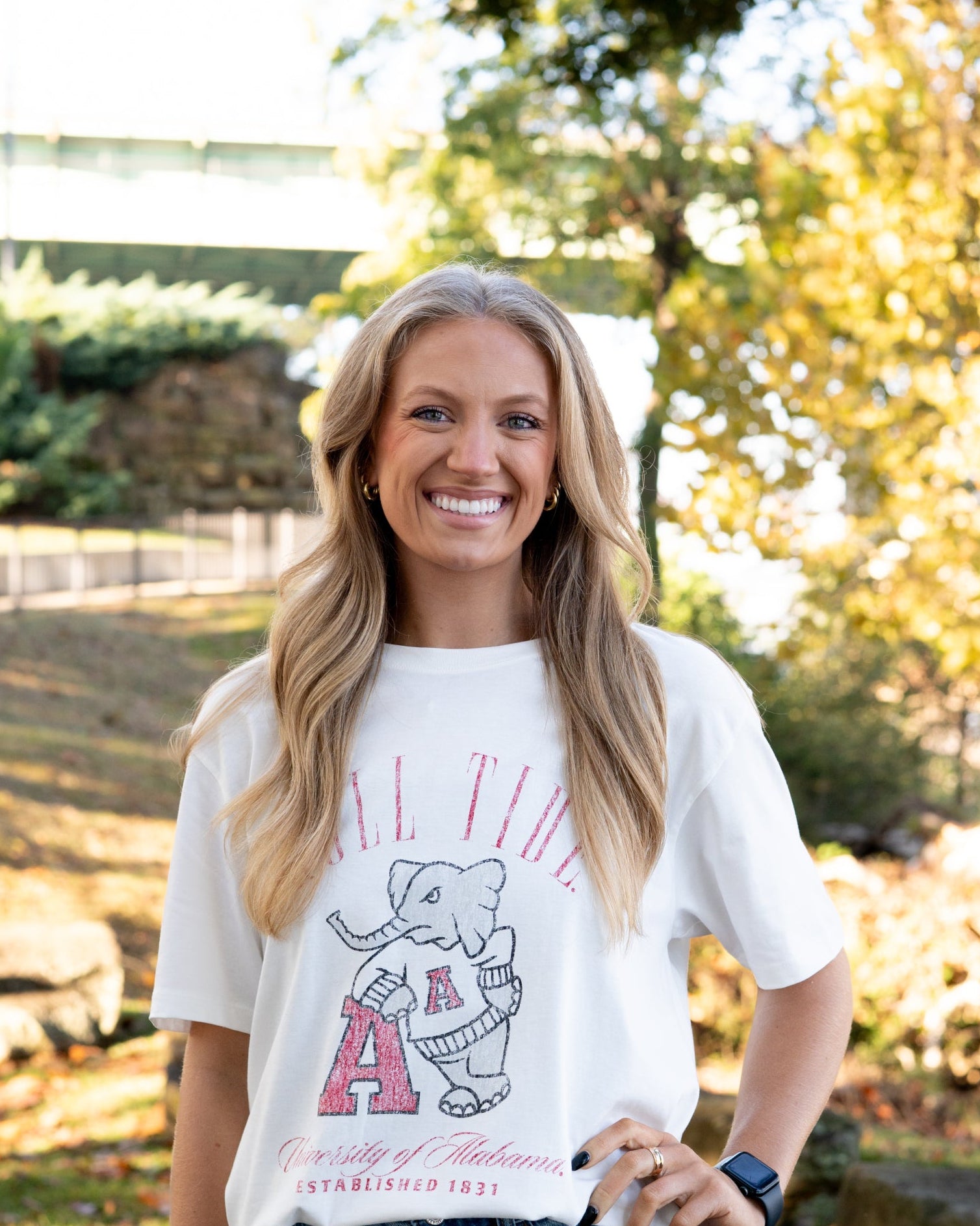 University of Alabama Ivory T-Shirt with Red text “Roll Tide” above an image of Big Al leaning on a Black A