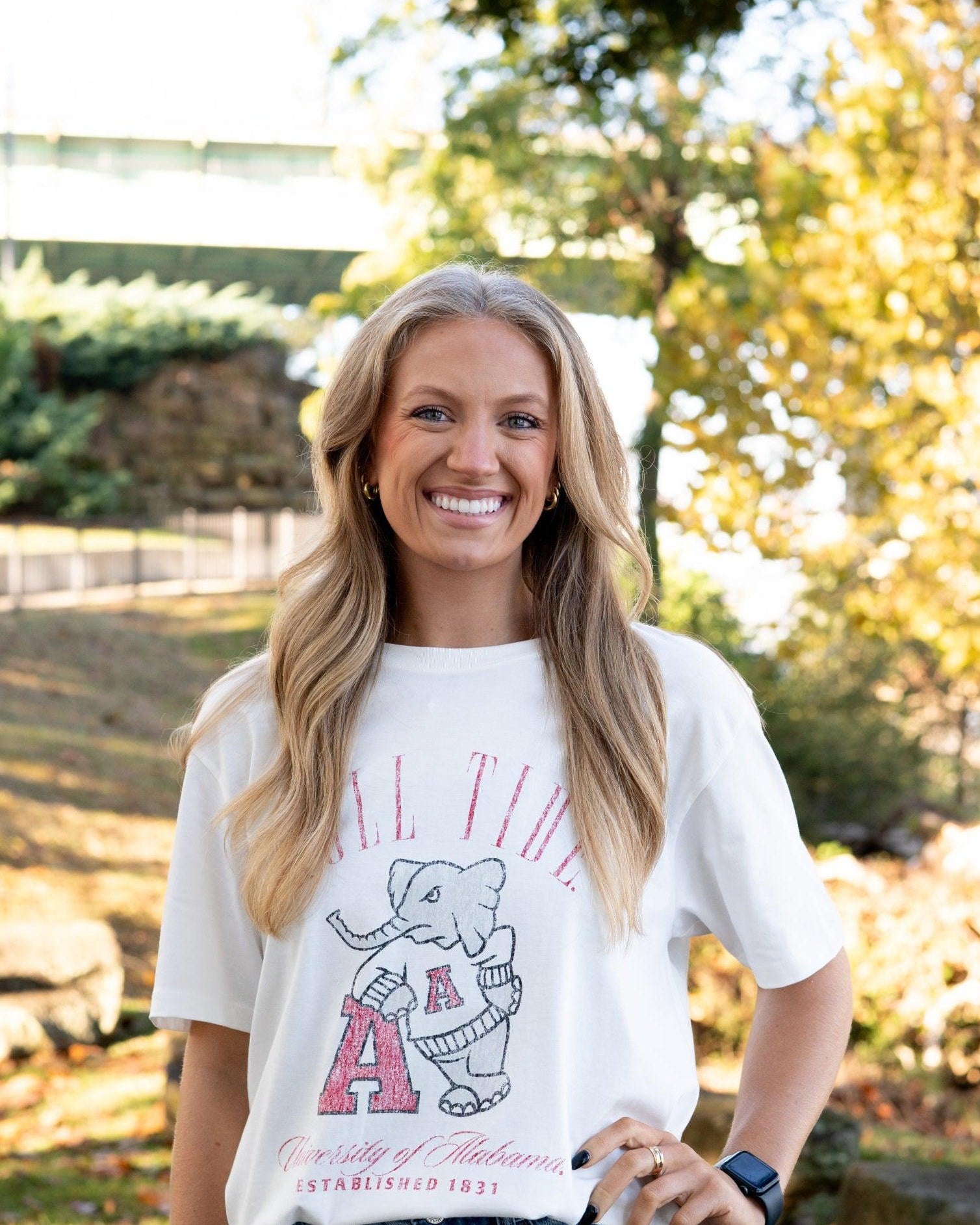 University of Alabama Ivory T-Shirt with Red text “Roll Tide” above an image of Big Al leaning on a Black A