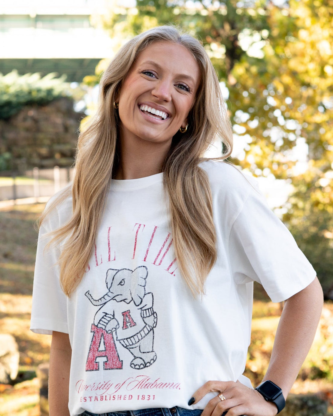 University of Alabama Ivory T-Shirt with Red text “Roll Tide” above an image of Big Al leaning on a Black A