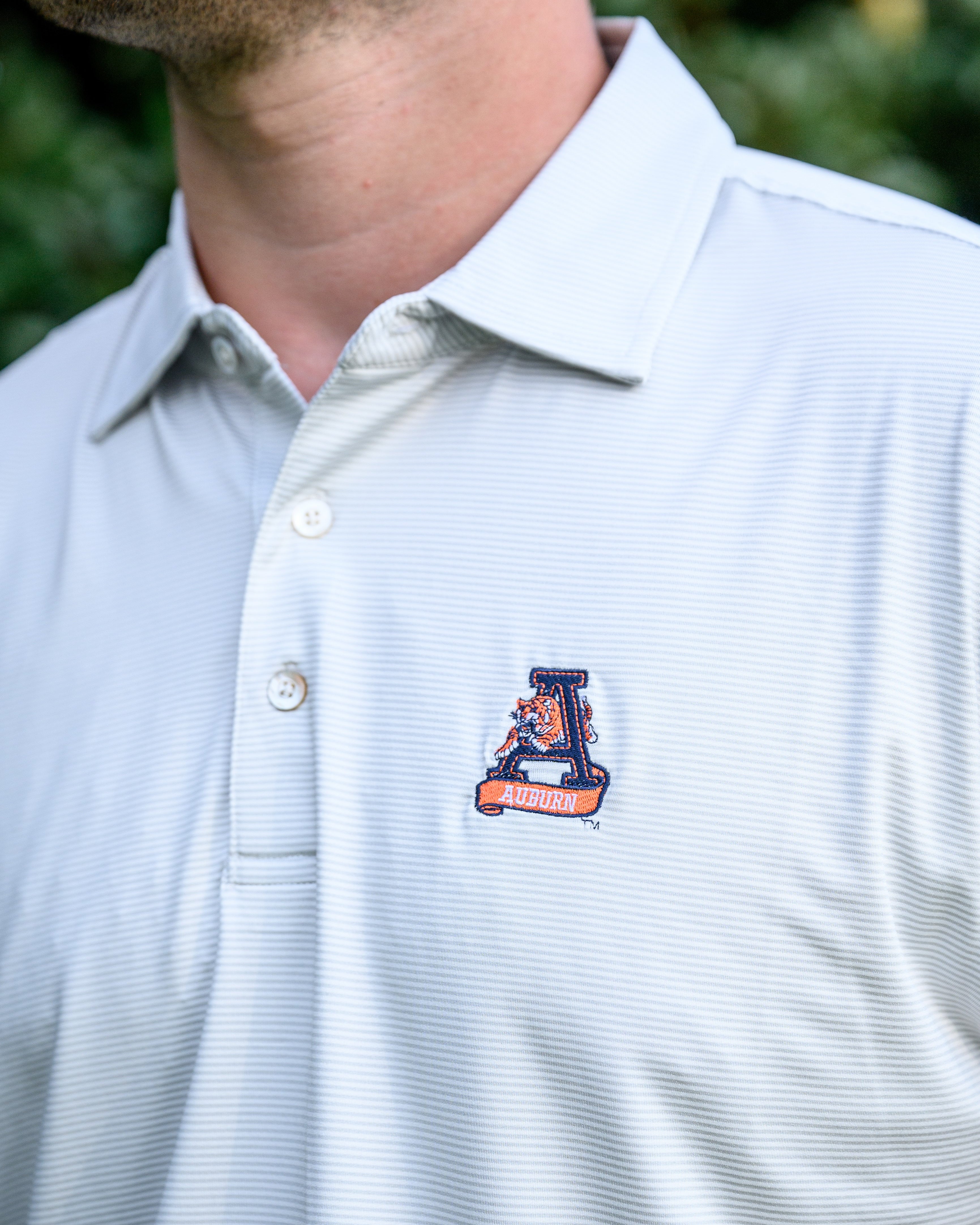 Auburn University Light Grey Men’s Polo with embroidery of Aubie leaping through an "A"