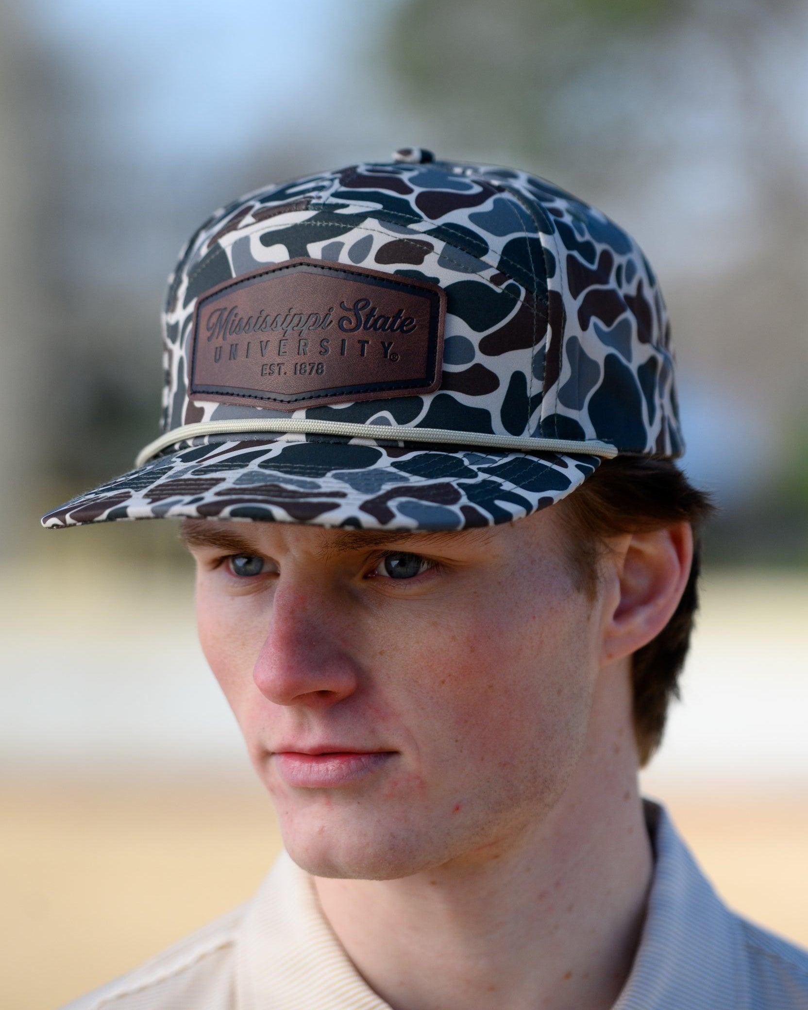 Mississippi State Camo Hat with a White rope and a leather patch with text “Mississippi State University”