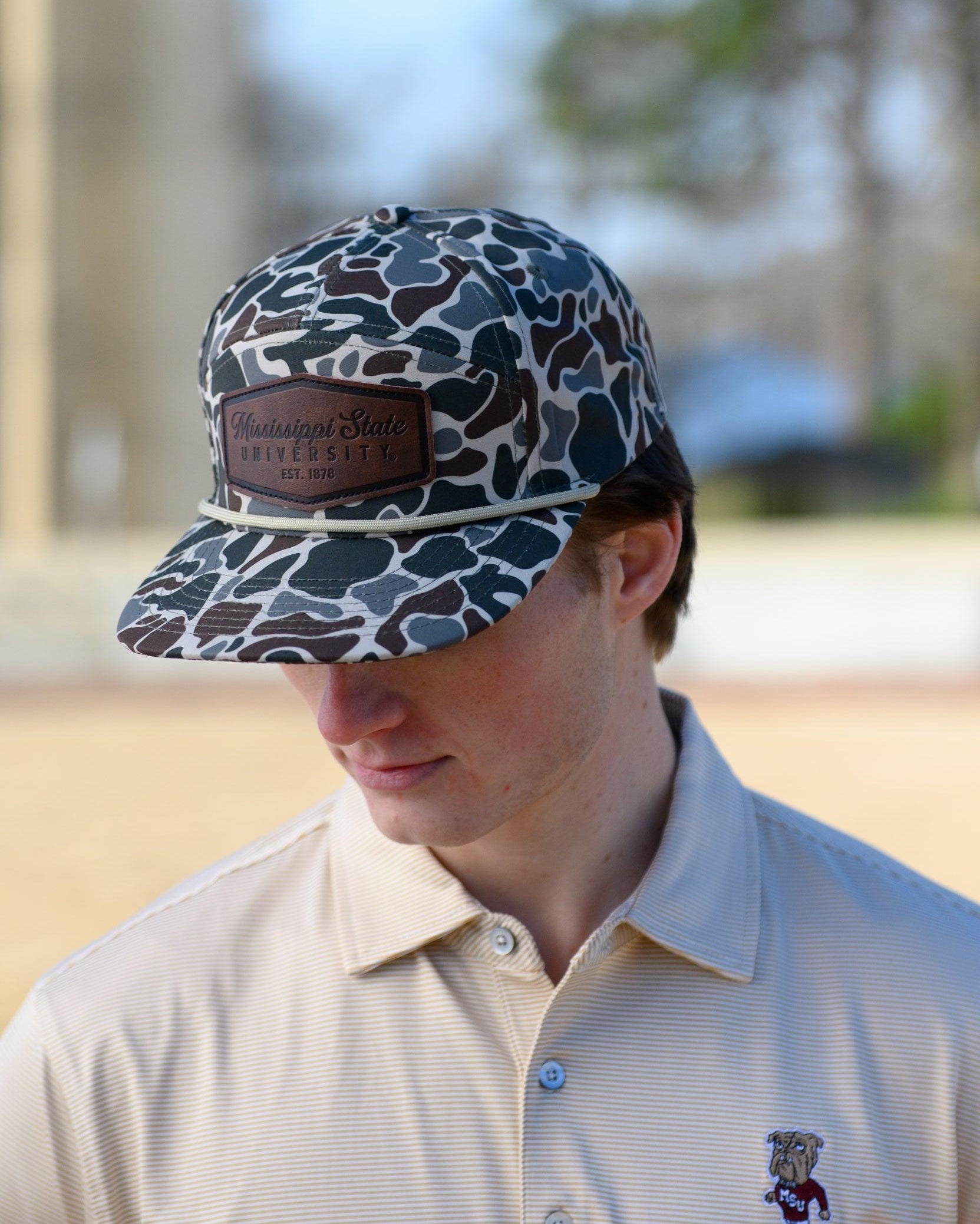 Mississippi State Camo Hat with a White rope and a leather patch with text “Mississippi State University”