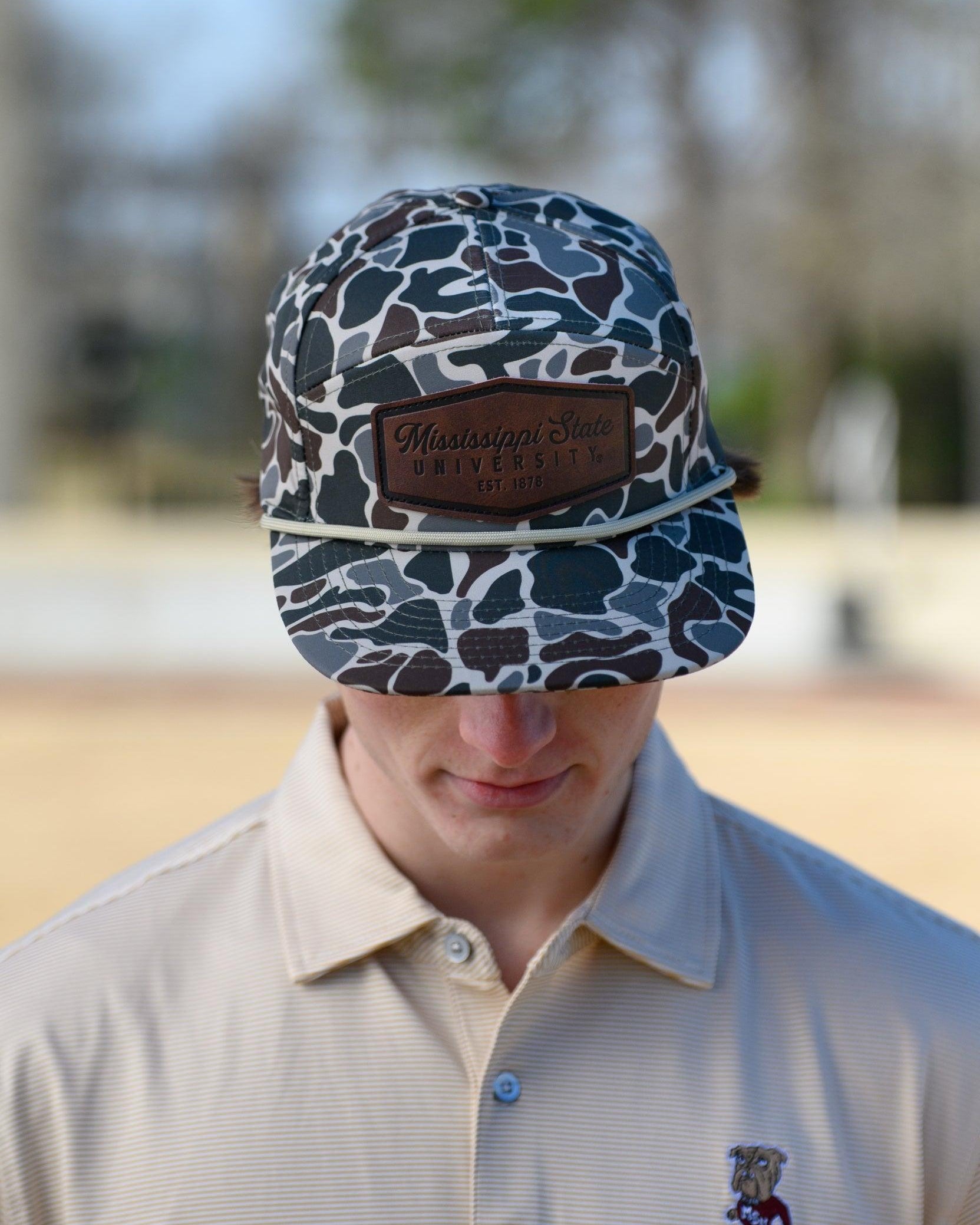 Mississippi State Camo Hat with a White rope and a leather patch with text “Mississippi State University”
