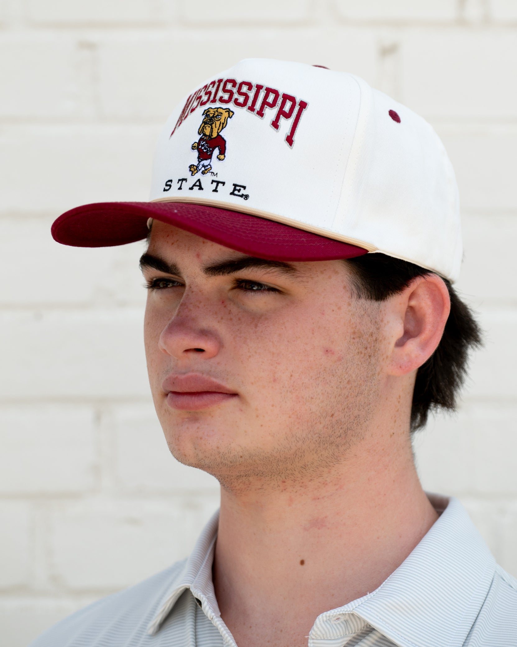 Mississippi State Cream and Maroon Hat with the Walking Bully Logo in between embroidered text “Mississippi State”