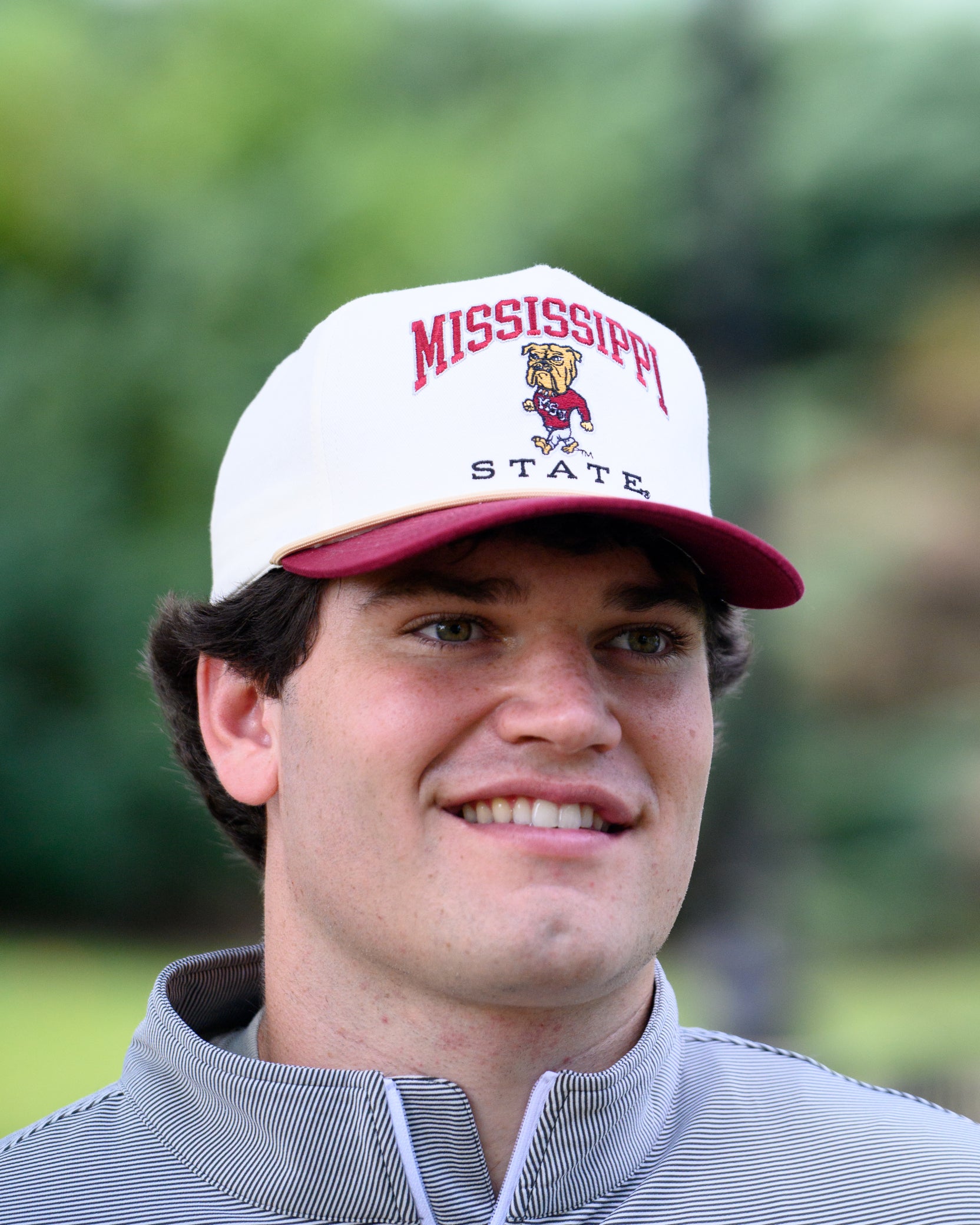 Mississippi State Cream and Maroon Hat with the Walking Bully Logo in between embroidered text “Mississippi State”