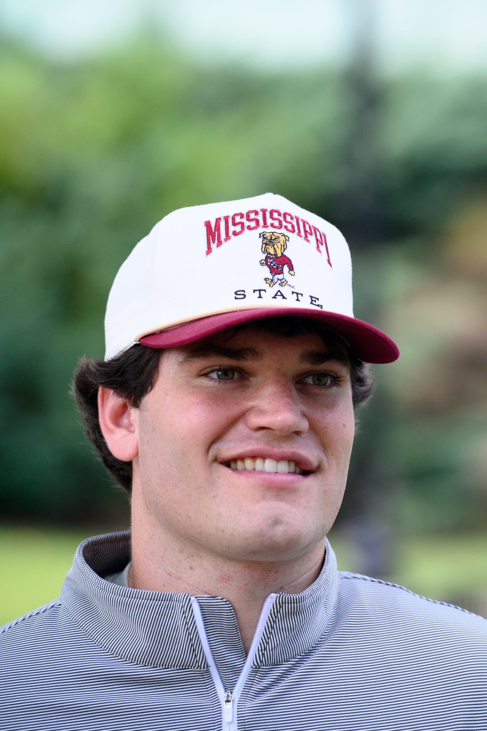 Mississippi State Cream and Maroon Hat with the Walking Bully Logo in between embroidered text “Mississippi State”