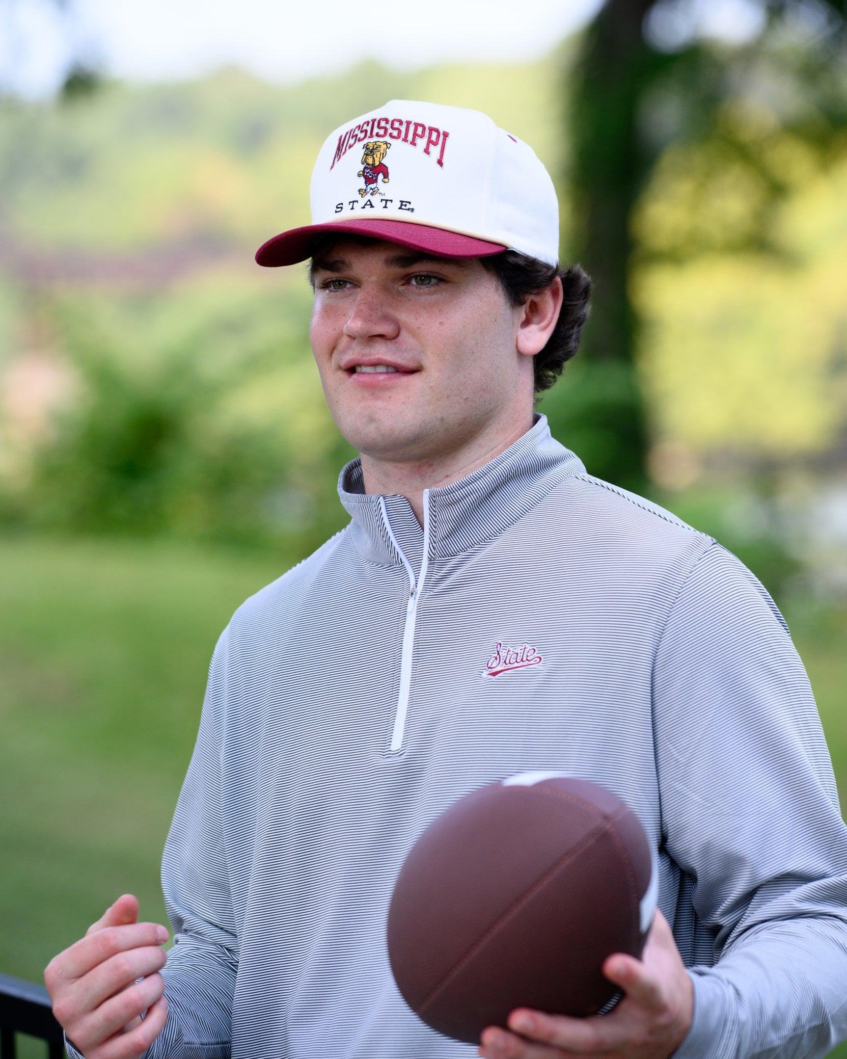 Mississippi State Cream and Maroon Hat with the Walking Bully Logo in between embroidered text “Mississippi State”