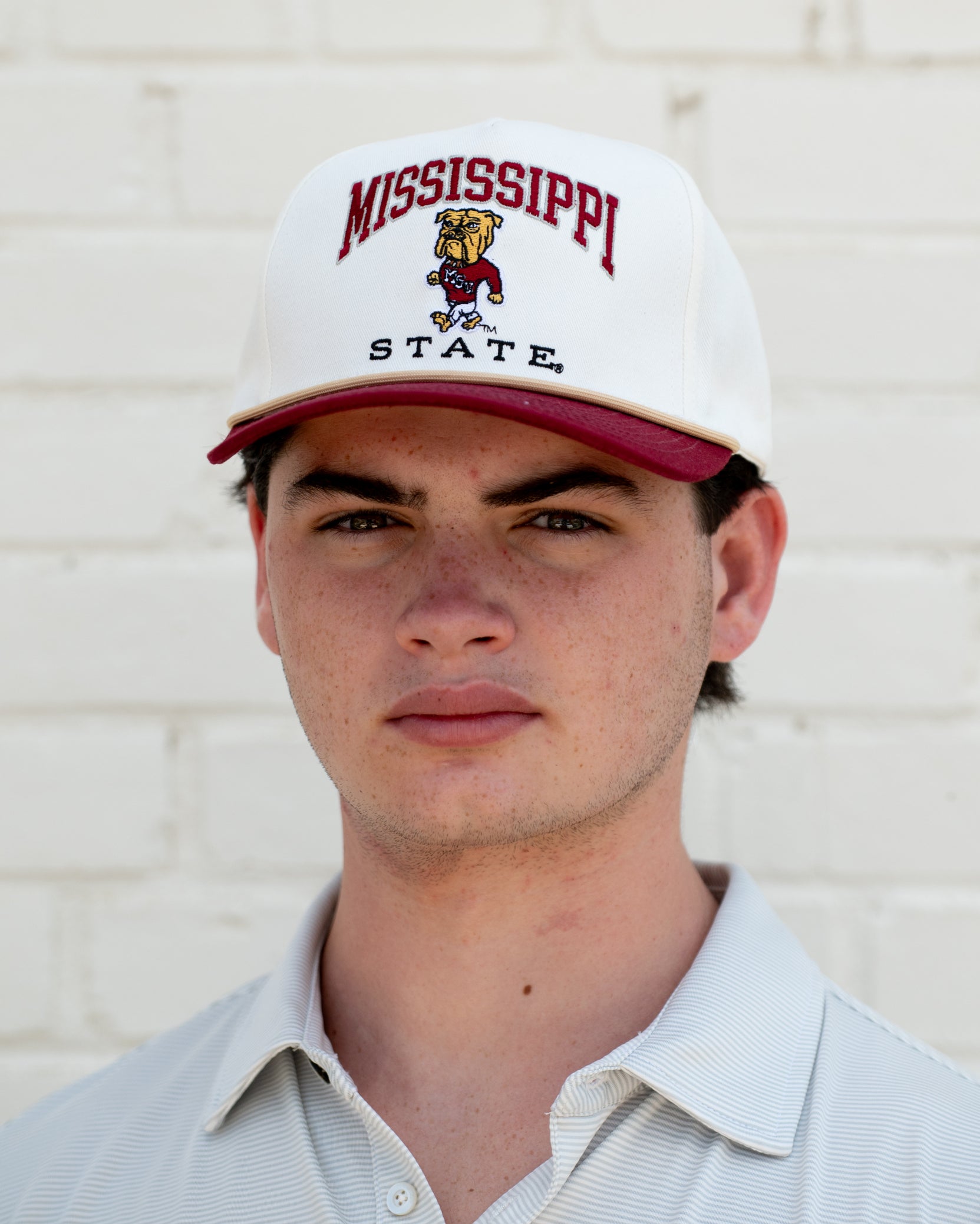 Mississippi State Cream and Maroon Hat with the Walking Bully Logo in between embroidered text “Mississippi State”