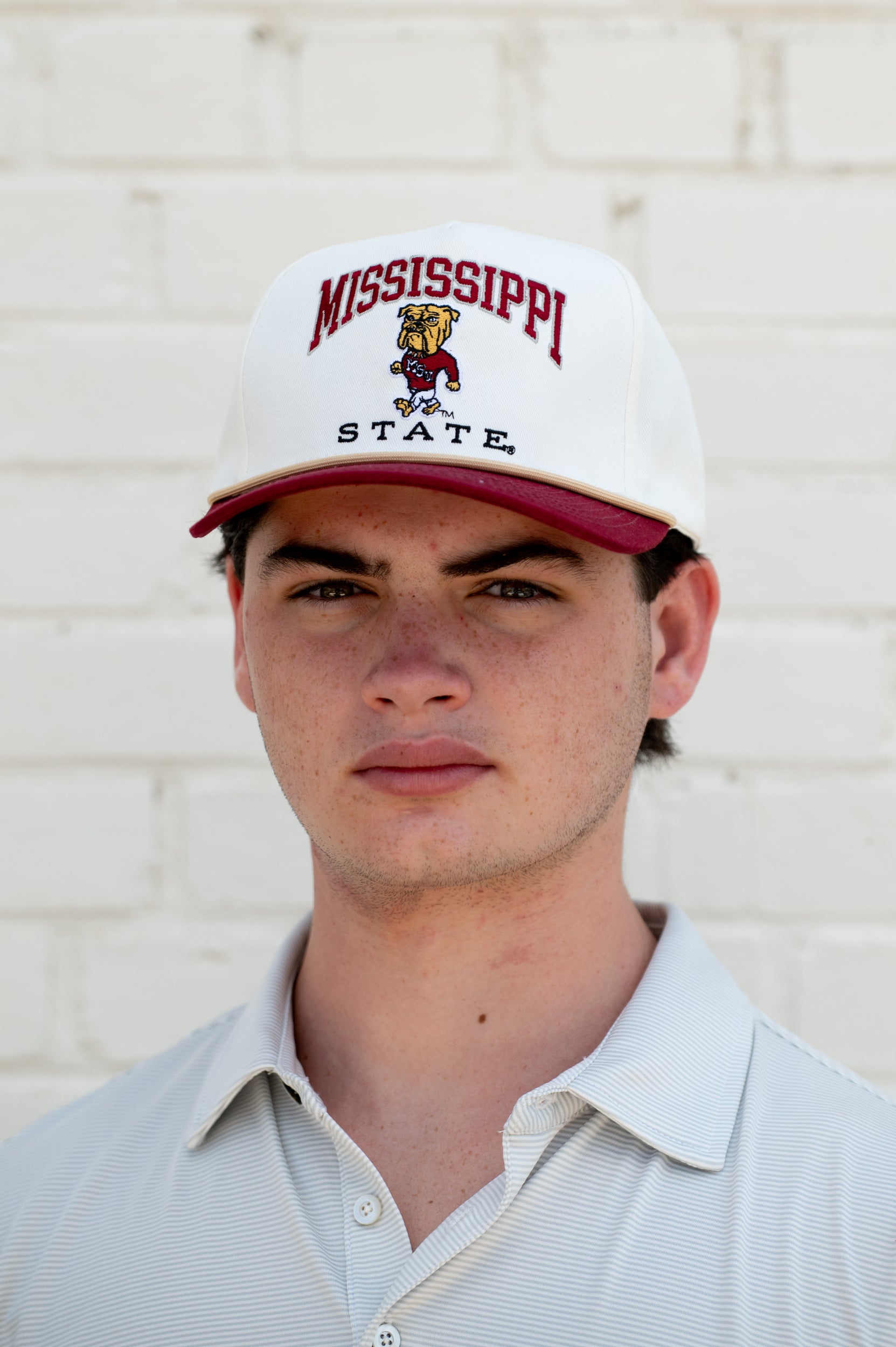 Mississippi State Cream and Maroon Hat with the Walking Bully Logo in between embroidered text “Mississippi State”