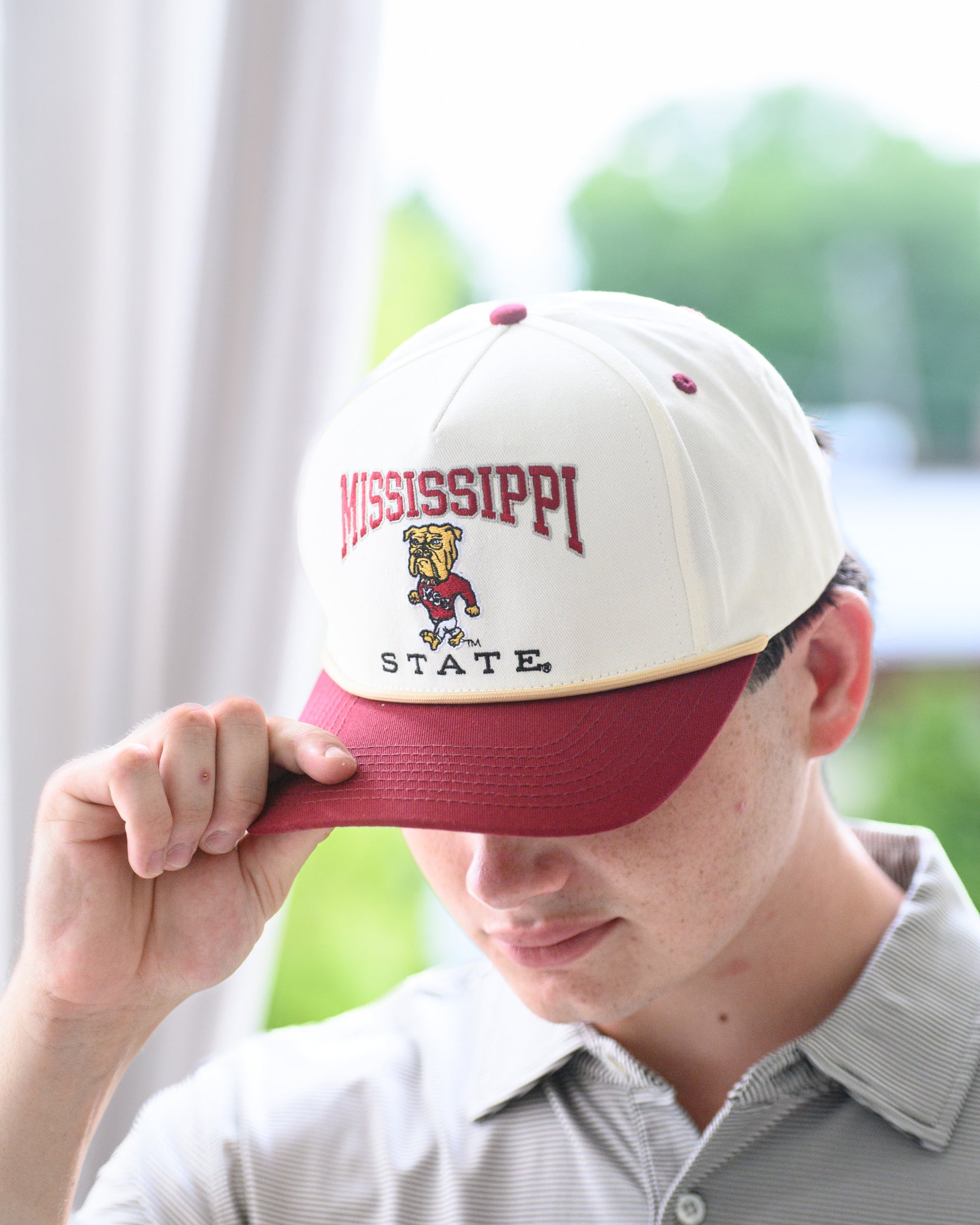 Mississippi State Cream and Maroon Hat with the Walking Bully Logo in between embroidered text “Mississippi State”