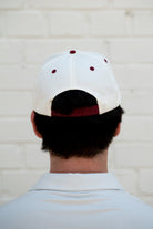 Mississippi State Cream and Maroon Hat with the Walking Bully Logo in between embroidered text “Mississippi State”