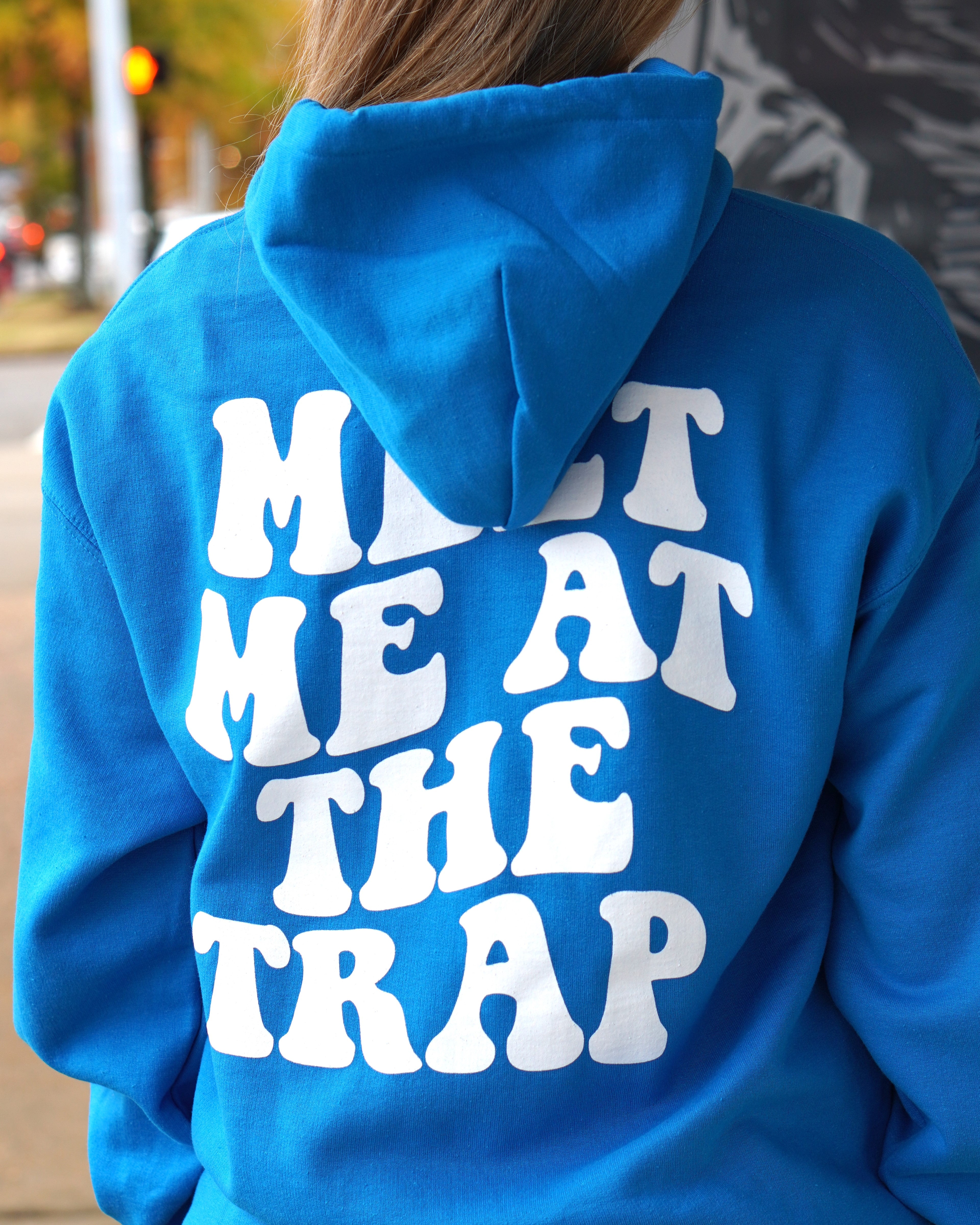 Bear Trap Blue Hoodie with 'MEET ME AT THE TRAP' printed in white text on the back.