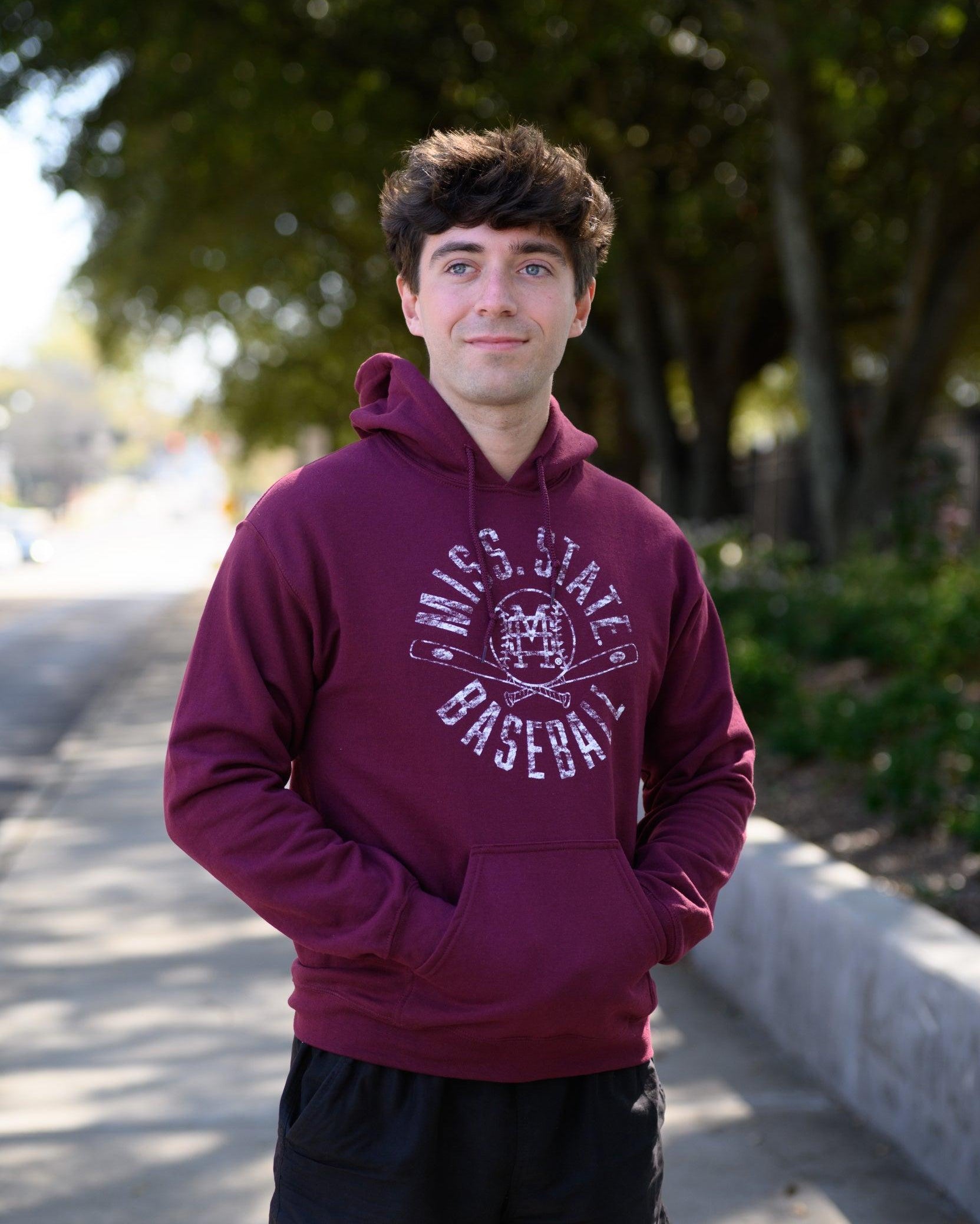 Mississippi State Distressed Dark Red Hoodie with a White Baseball featuring the MS overlapping logo over crossed baseball bats, surrounded by White text “Miss. State Baseball”