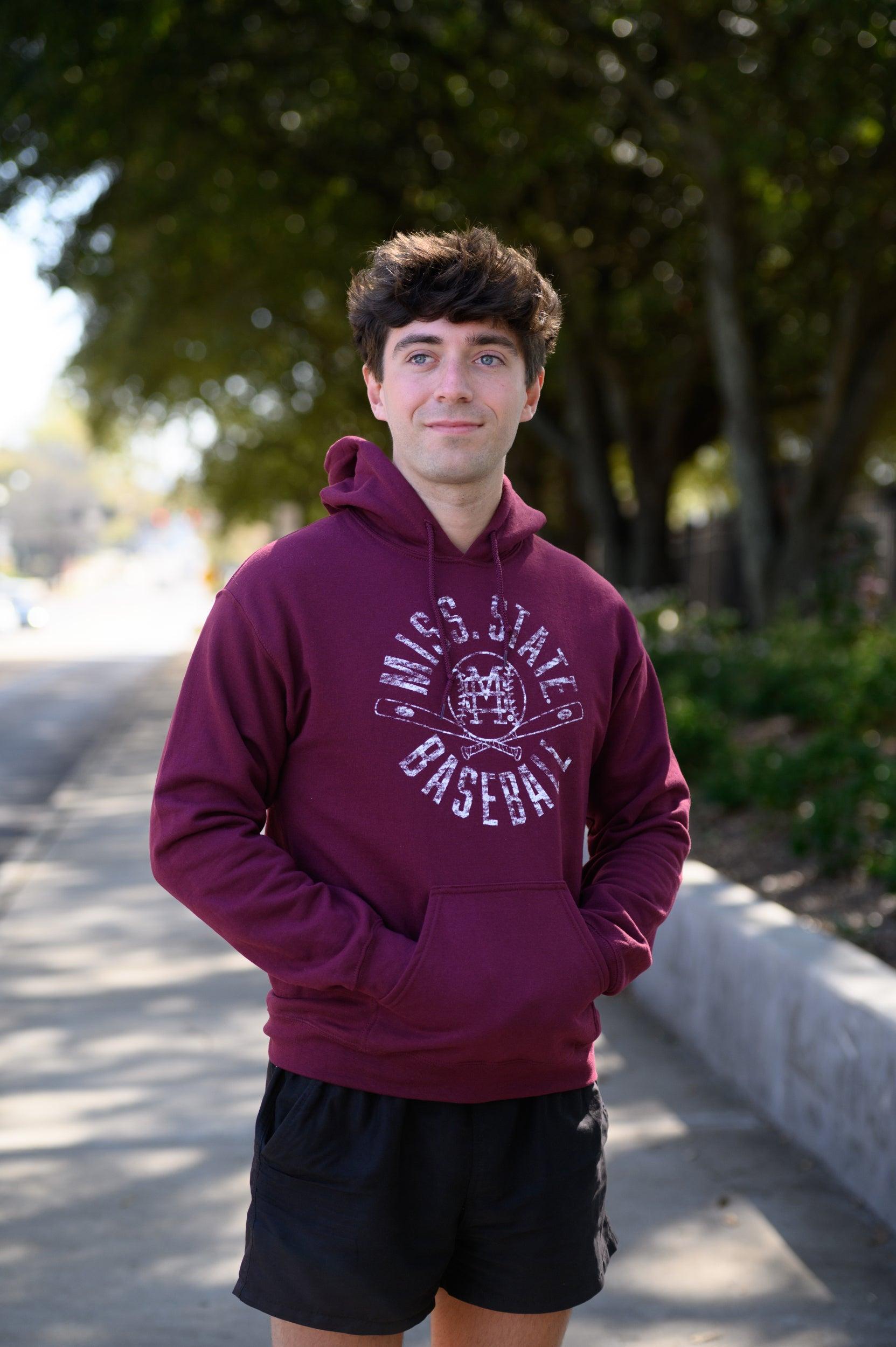 Mississippi State Distressed Dark Red Hoodie with a White Baseball featuring the MS overlapping logo over crossed baseball bats, surrounded by White text “Miss. State Baseball”