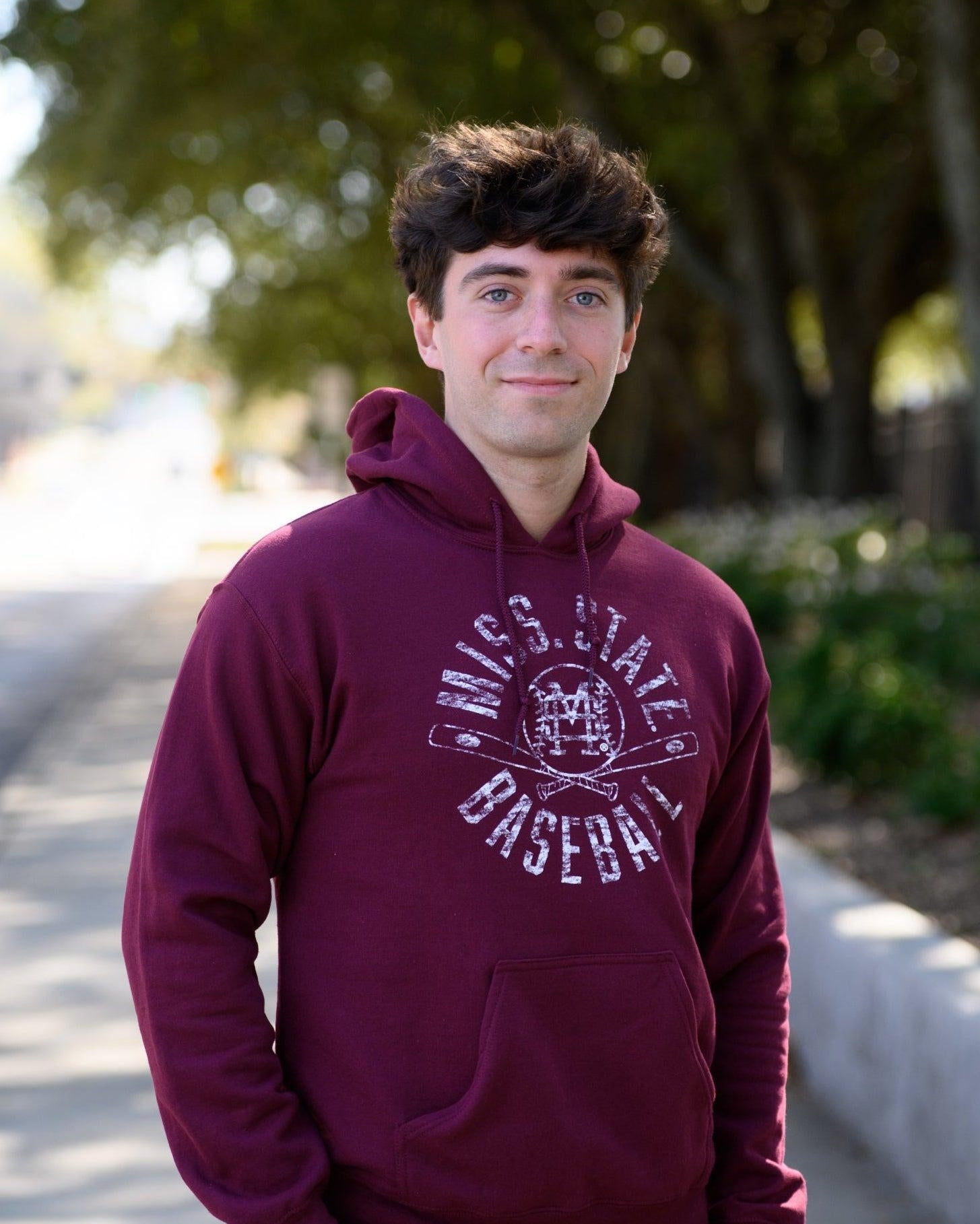 Mississippi State Distressed Dark Red Hoodie with a White Baseball featuring the MS overlapping logo over crossed baseball bats, surrounded by White text “Miss. State Baseball”