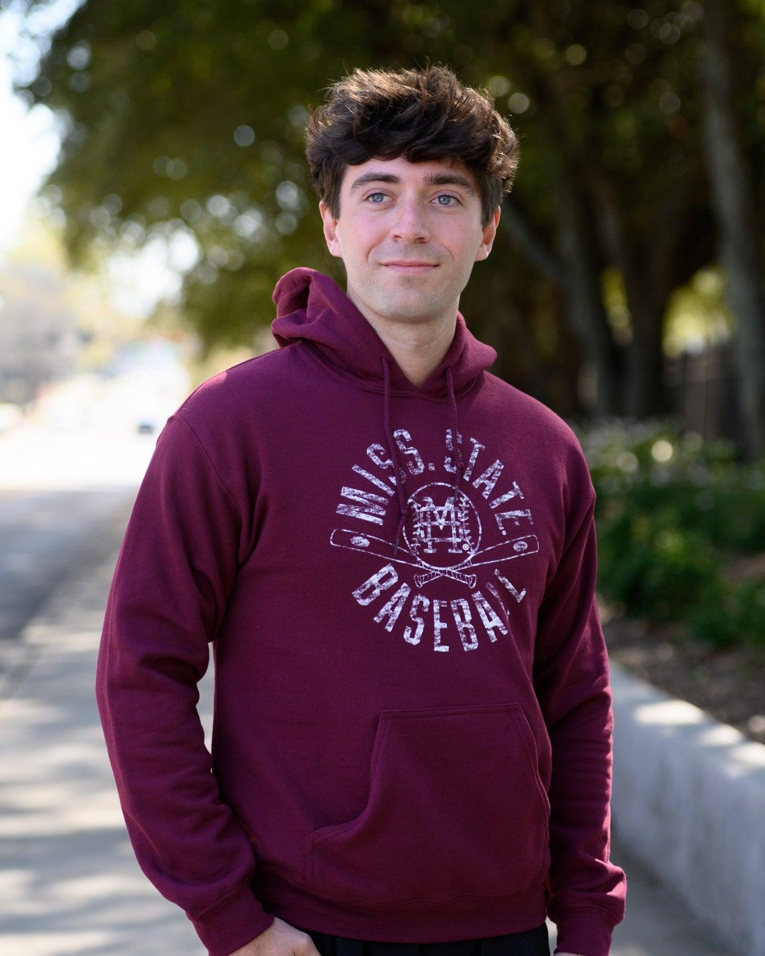 Mississippi State Distressed Dark Red Hoodie with a White Baseball featuring the MS overlapping logo over crossed baseball bats, surrounded by White text “Miss. State Baseball”