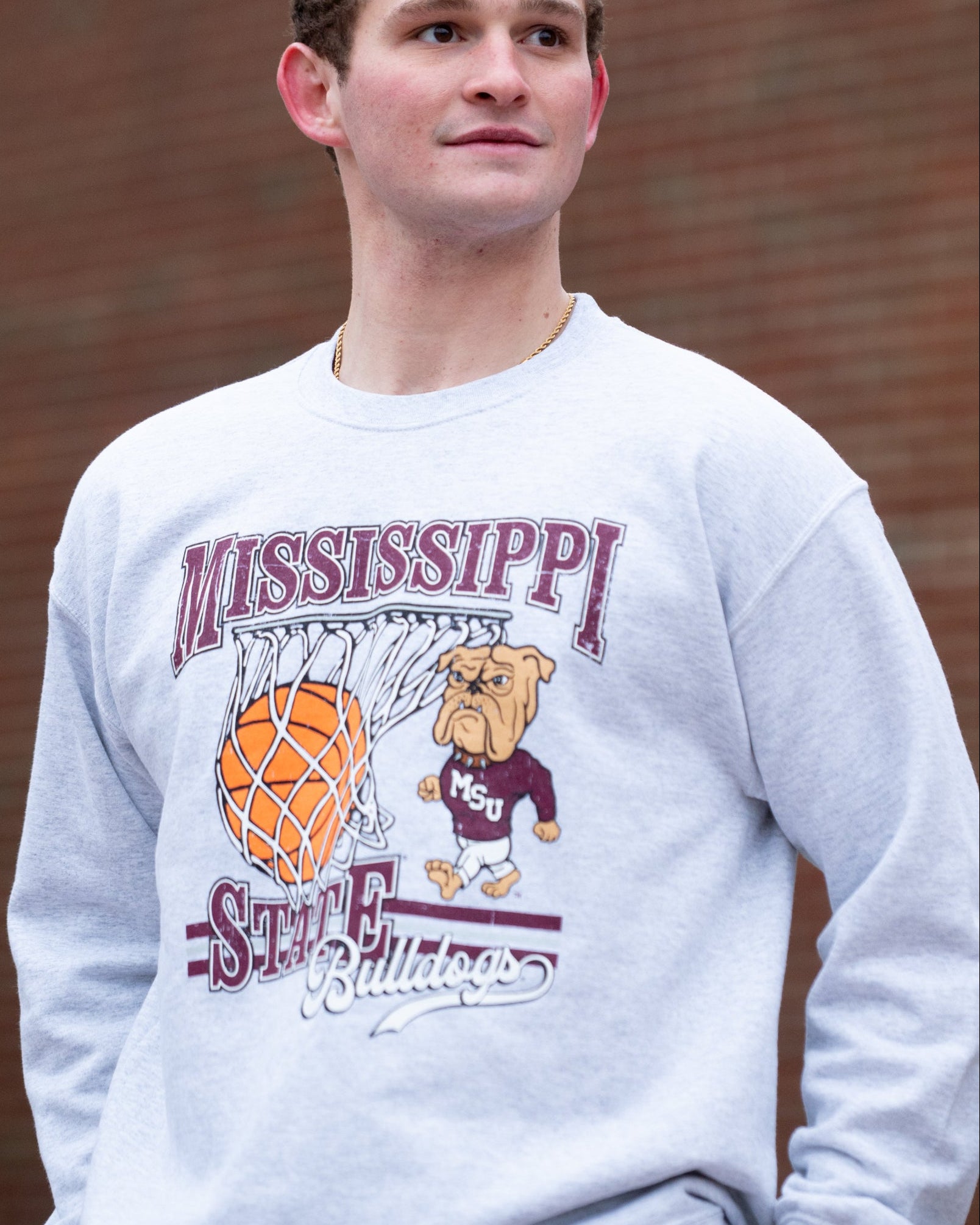 Mississippi State Light Grey Heather Sweatshirt with a basketball landing in a hoop between text “Mississippi” and “State” and next to Bully