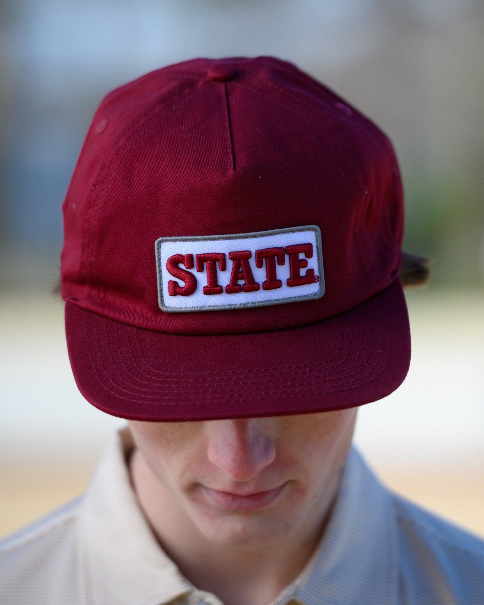Mississippi State Maroon Snapback Hat featuring a White patch with Maroon “State” embroidery