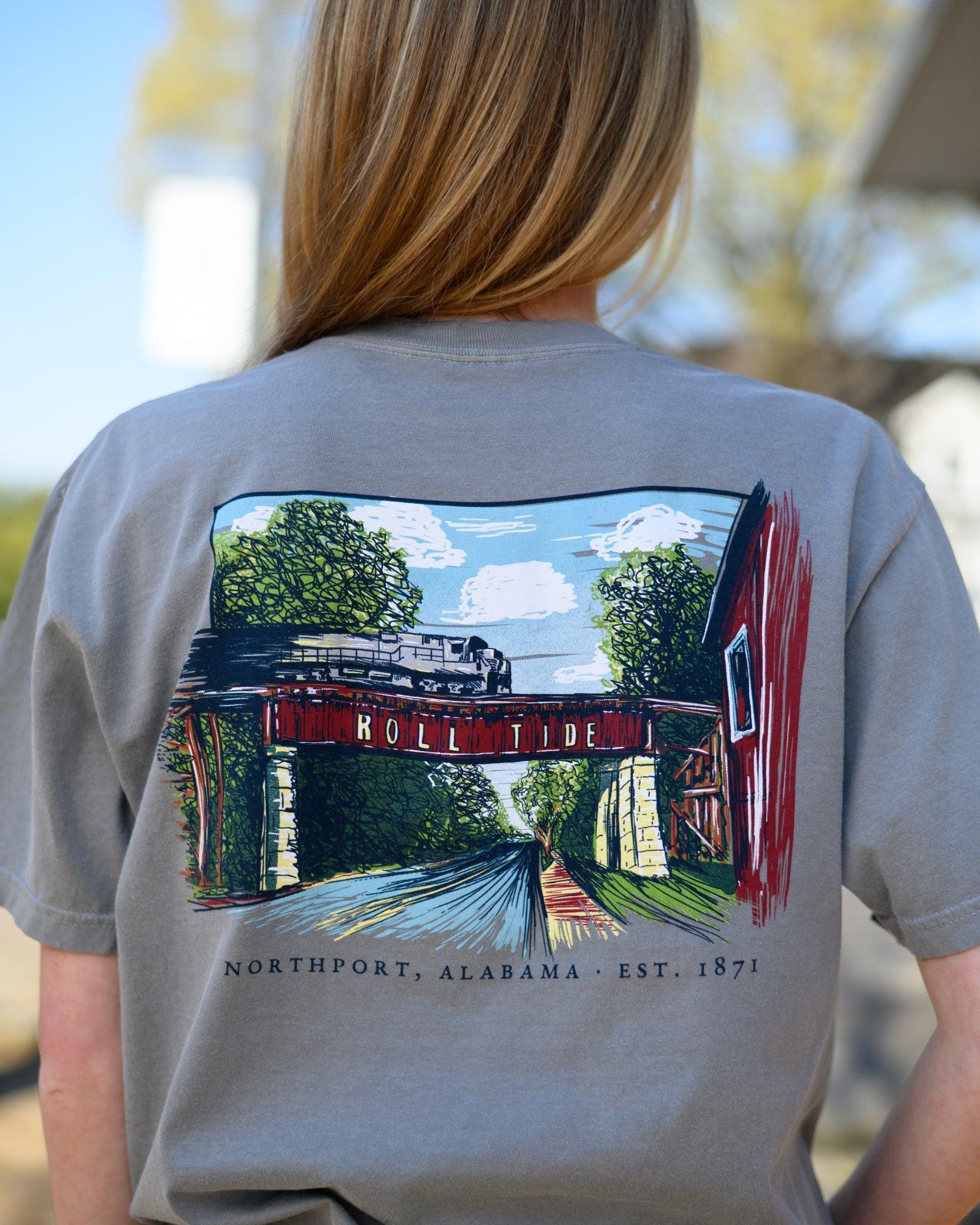 Local Merch Grey T-Shirt with a hand-drawn illustration of the Downtown Northport Train tracks above Black text "Northport, Alabama EST. 1871"