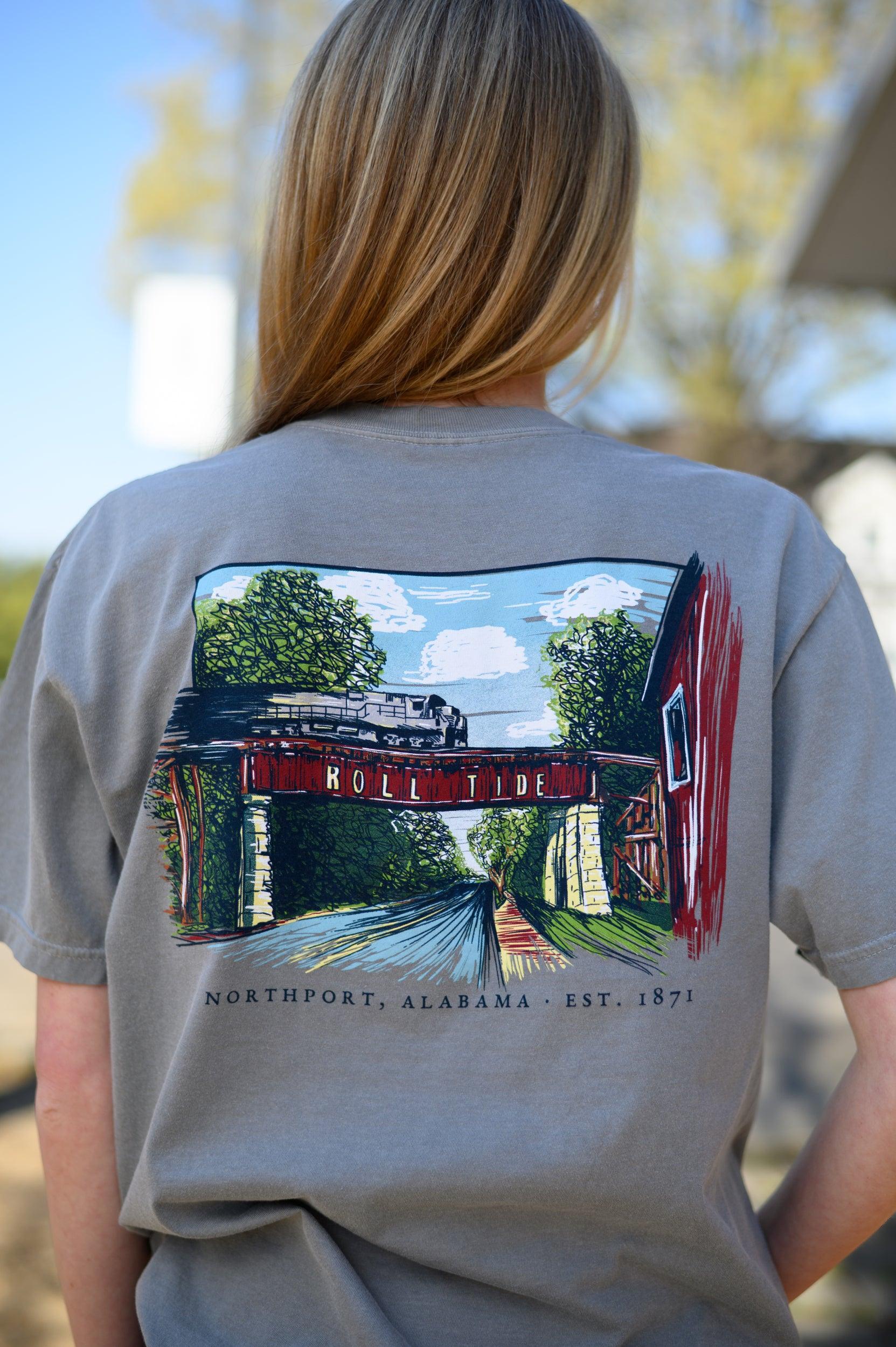 Local Merch Grey T-Shirt with a hand-drawn illustration of the Downtown Northport Train tracks above Black text "Northport, Alabama EST. 1871"