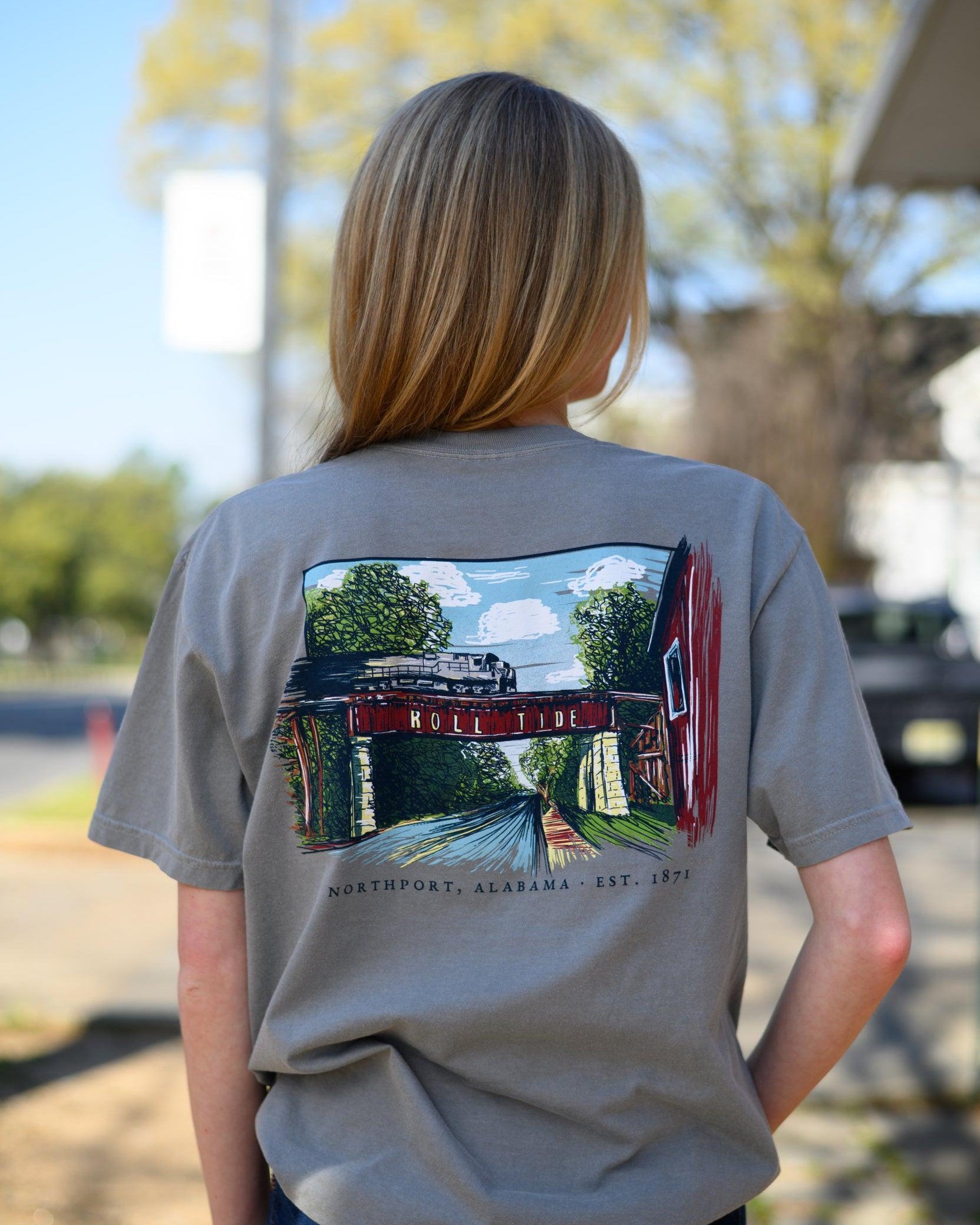 Local Merch Grey T-Shirt with a hand-drawn illustration of the Downtown Northport Train tracks above Black text "Northport, Alabama EST. 1871"