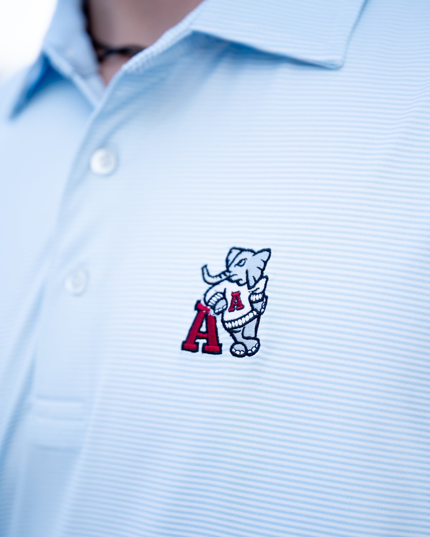 University of Alabama Light Blue Men’s Stripe Polo with embroidery of Big Al leaning on a Red Block A
