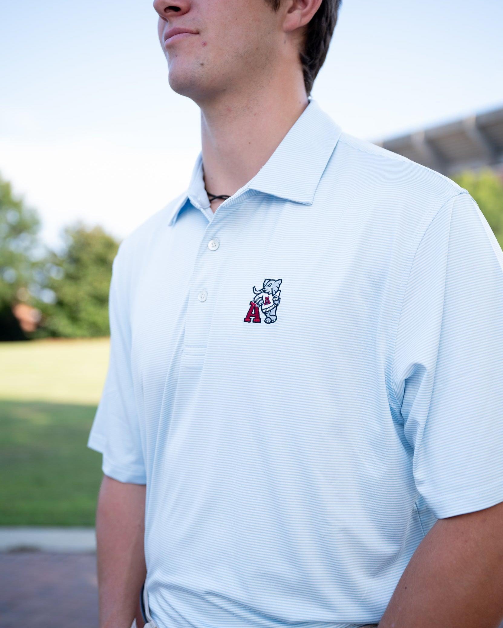 University of Alabama Light Blue Men’s Stripe Polo with embroidery of Big Al leaning on a Red Block A
