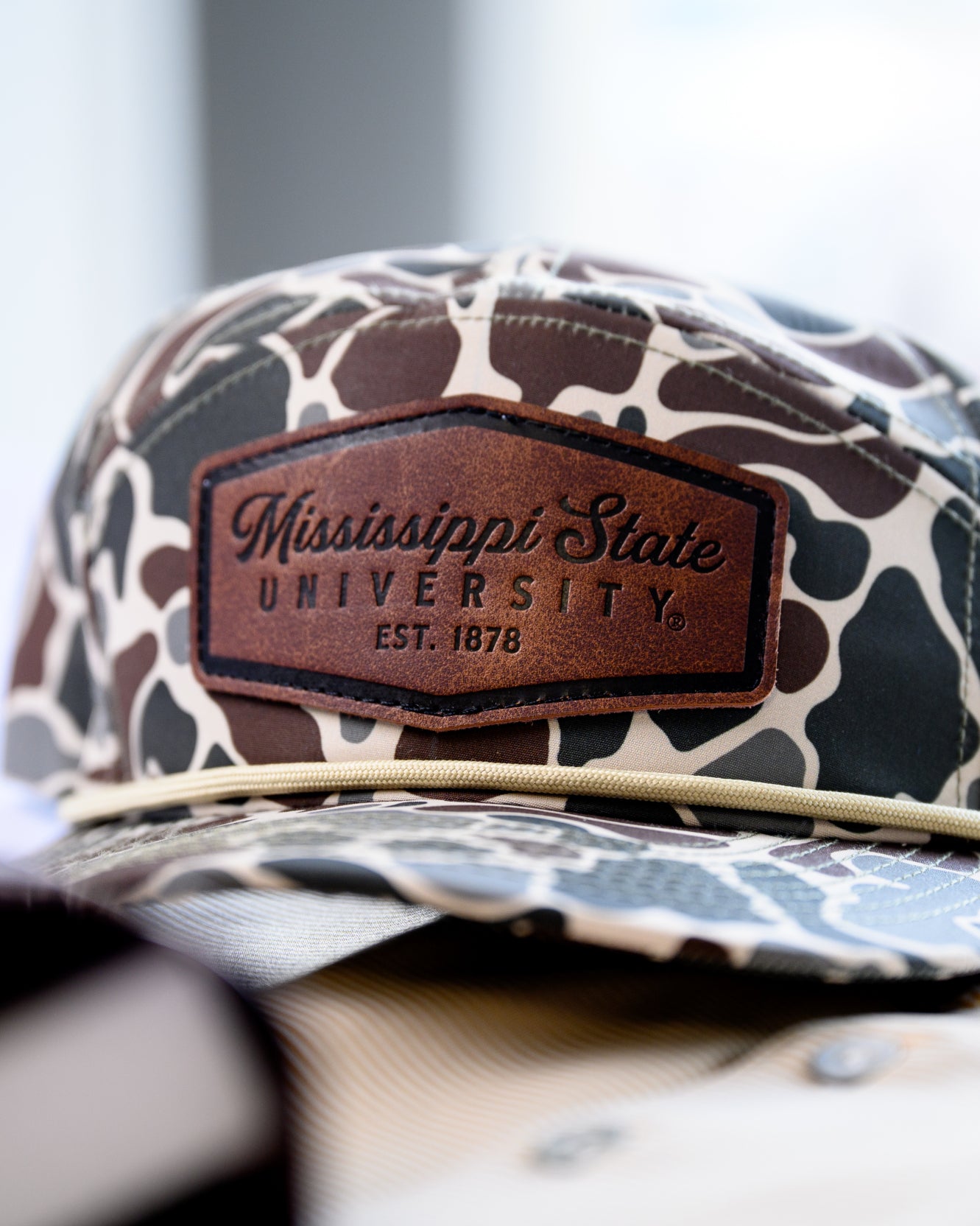 Ole Miss Camo Hat with a Leather patch with text “Mississippi University”