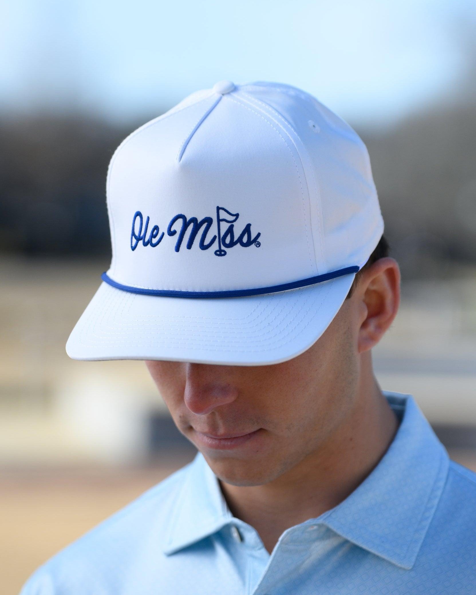 Ole Miss White Hat with Blue embroidery “Ole Miss” with a golf flag representing the “I” in “Miss”