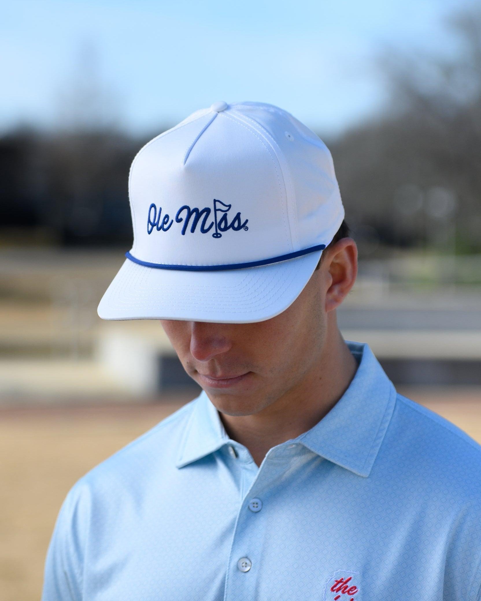 Ole Miss White Hat with Blue embroidery “Ole Miss” with a golf flag representing the “I” in “Miss”