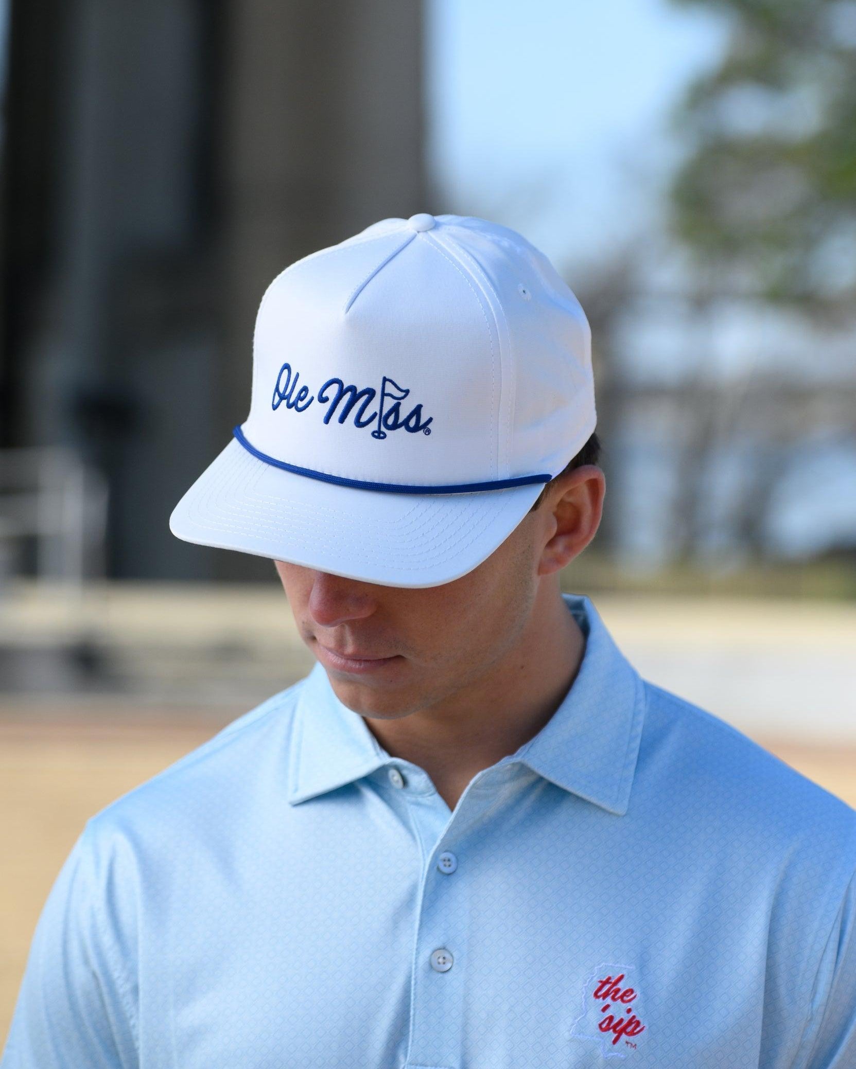 Ole Miss White Hat with Blue embroidery “Ole Miss” with a golf flag representing the “I” in “Miss”