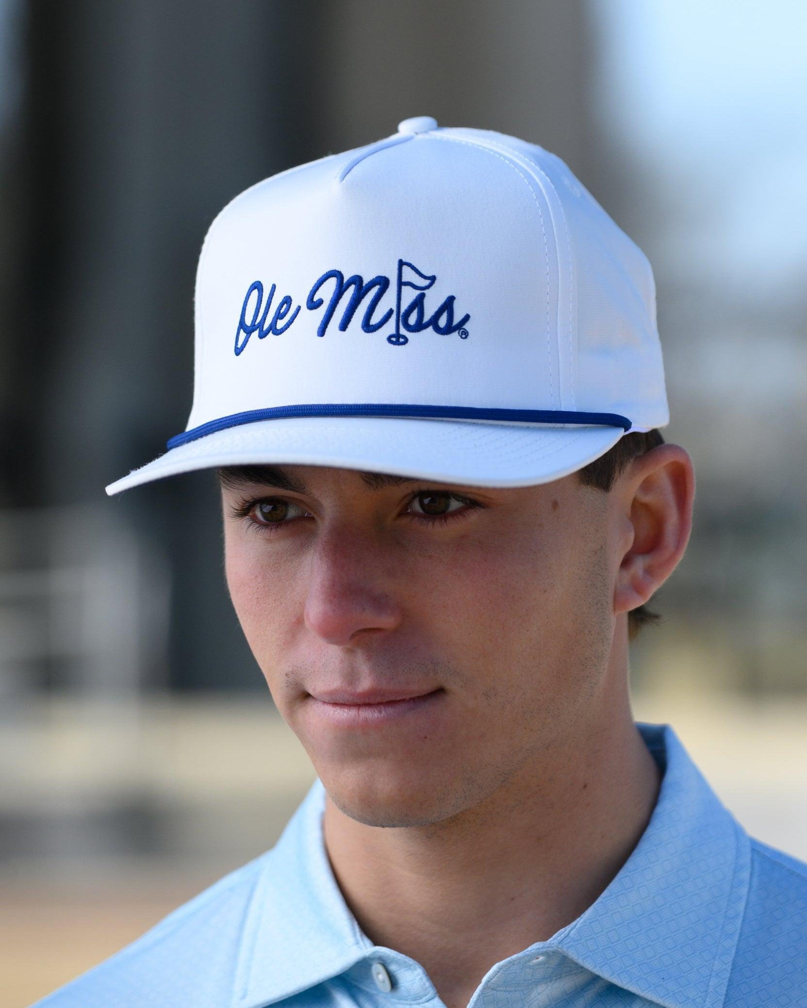 Ole Miss White Hat with Blue embroidery “Ole Miss” with a golf flag representing the “I” in “Miss”