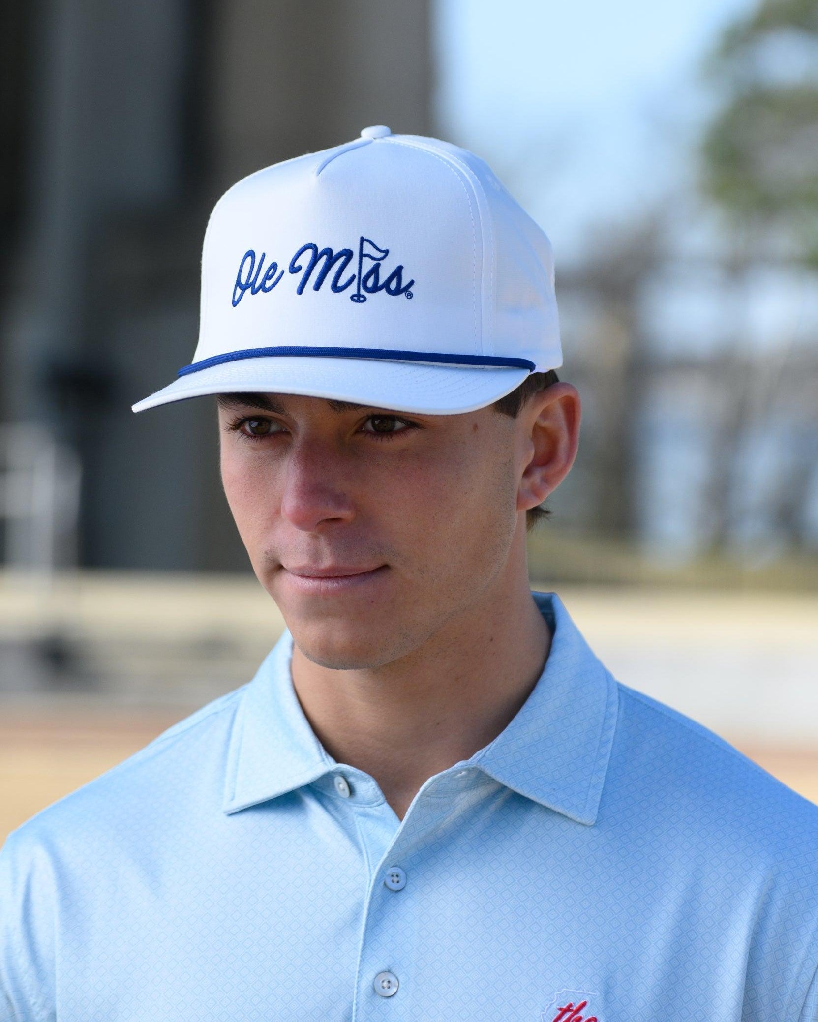 Ole Miss White Hat with Blue embroidery “Ole Miss” with a golf flag representing the “I” in “Miss”