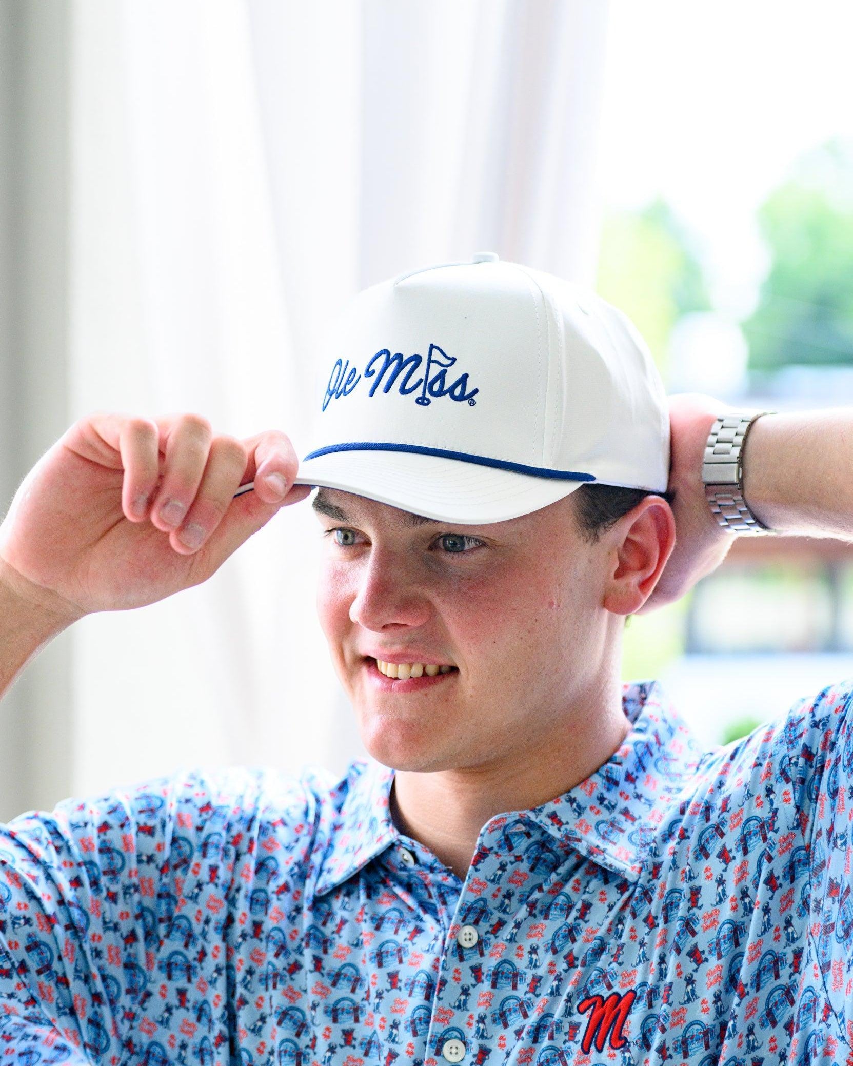 Ole Miss White Hat with Blue embroidery “Ole Miss” with a golf flag representing the “I” in “Miss”