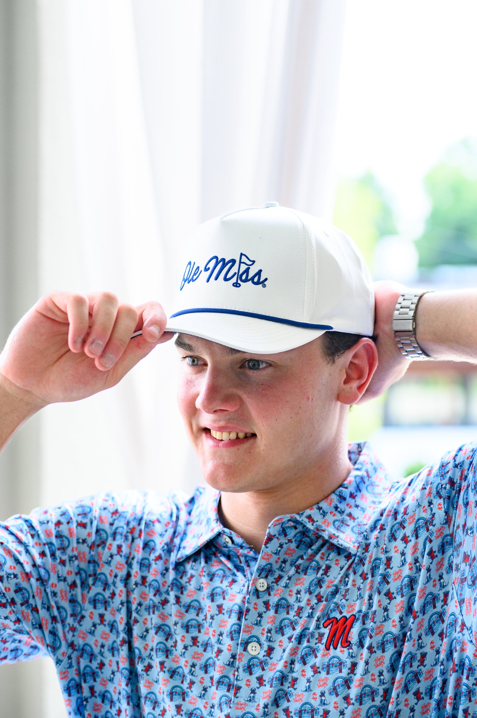 Ole Miss White Hat with Blue embroidery “Ole Miss” with a golf flag representing the “I” in “Miss”