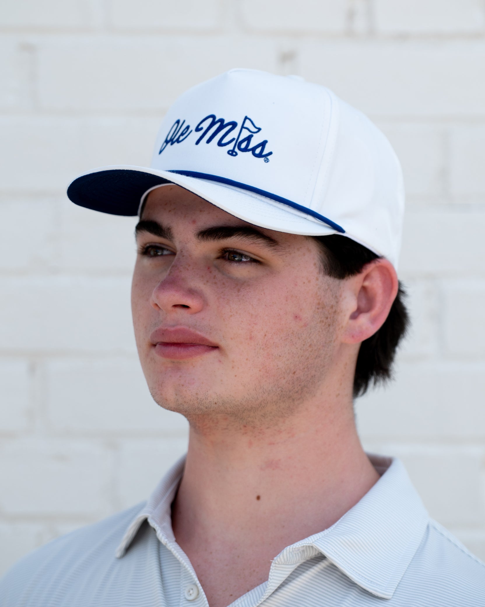 Ole Miss White Hat with Blue embroidery “Ole Miss” with a golf flag representing the “I” in “Miss”