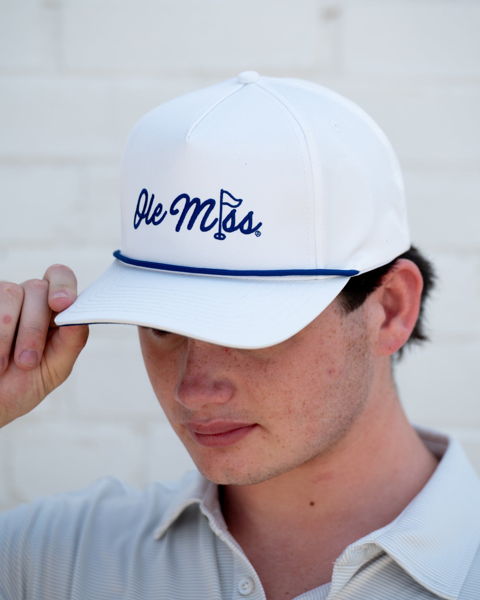 Ole Miss White Hat with Blue embroidery “Ole Miss” with a golf flag representing the “I” in “Miss”